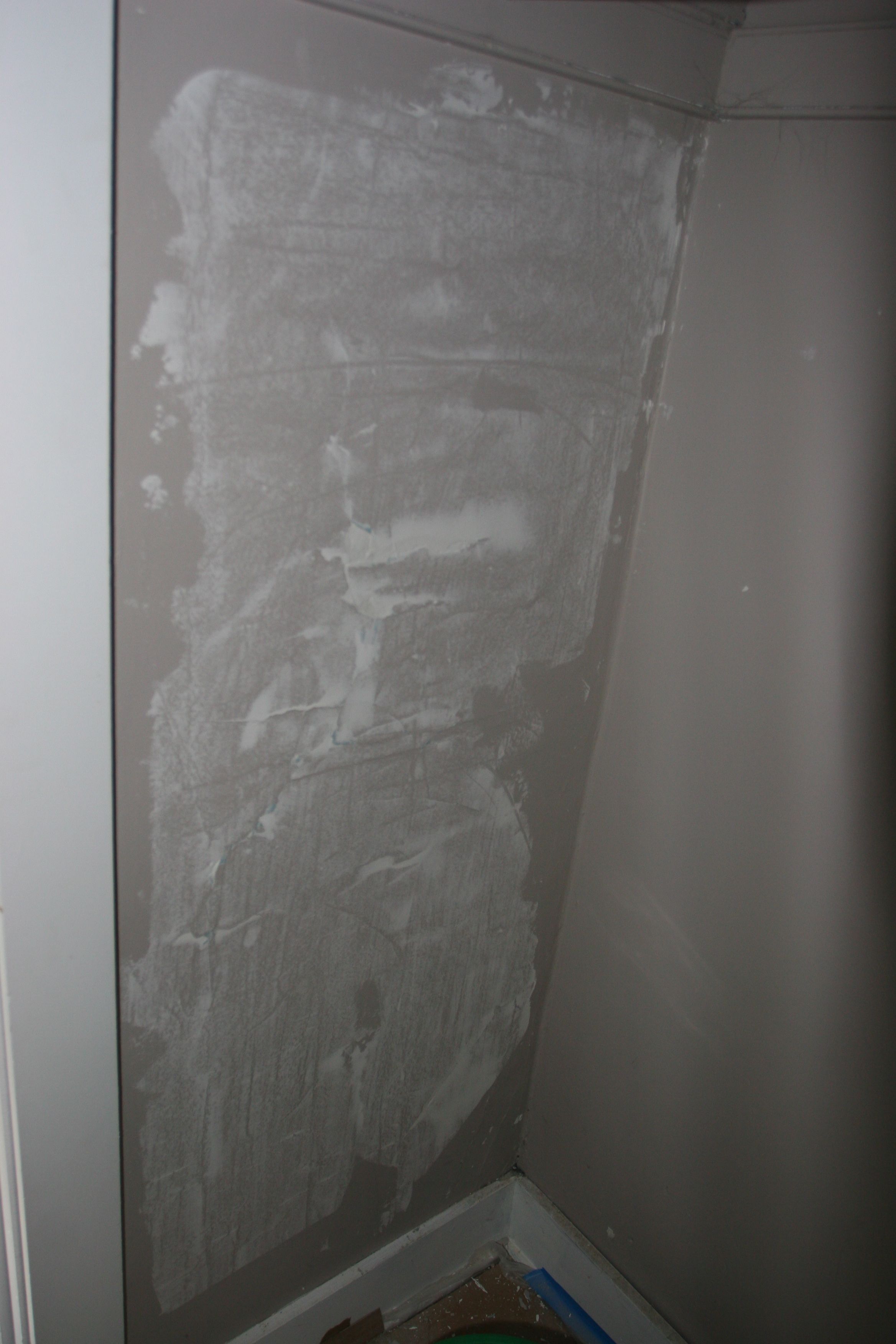First skim coat to remedy hammer-stressed plaster in master closet.
