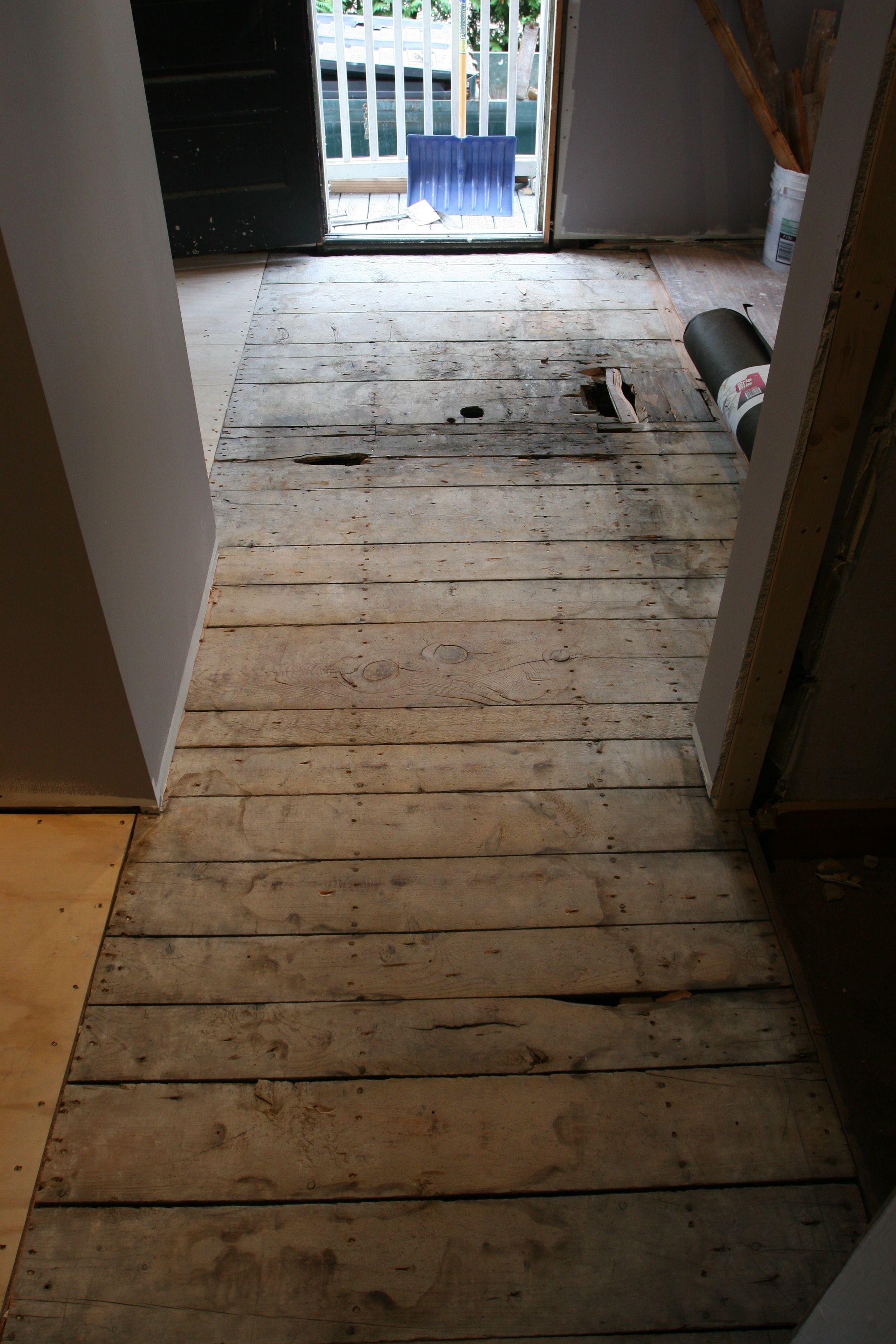 Eric prepared the floor by removing some of the old wood (patched from eons ago) and re-nailing down the subfloor.