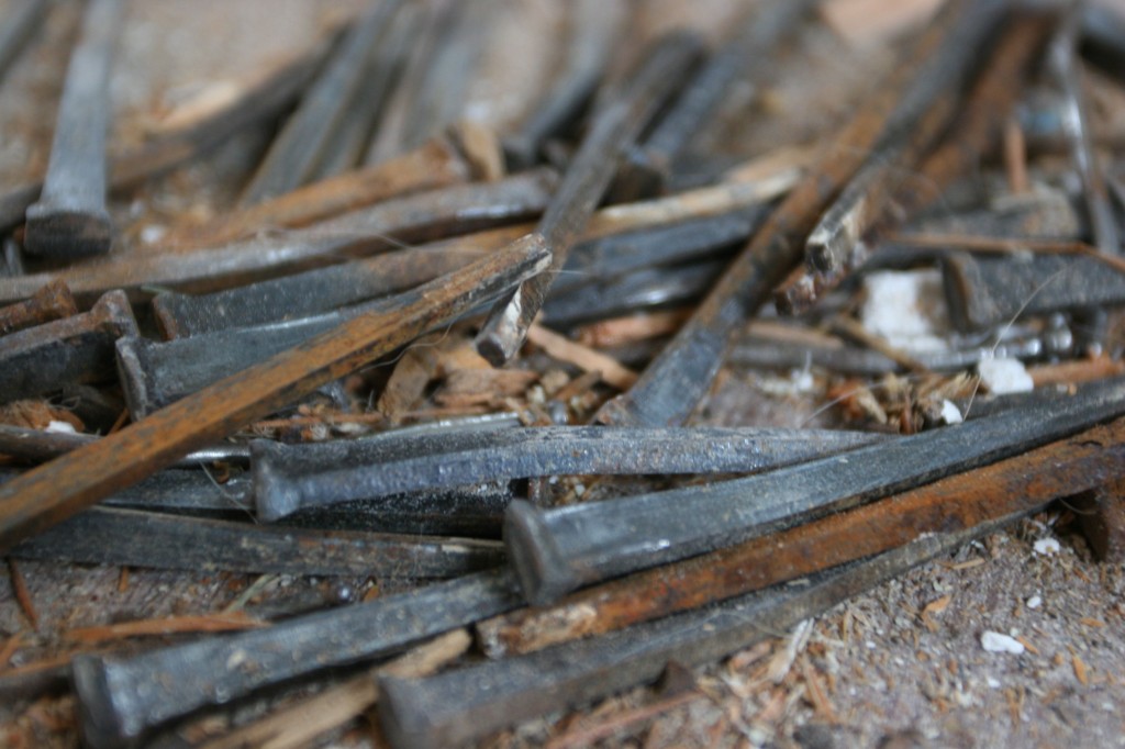 Piles of old hand-forged square nails were pulled out of the antique boards so we can re-use the wood upstairs.