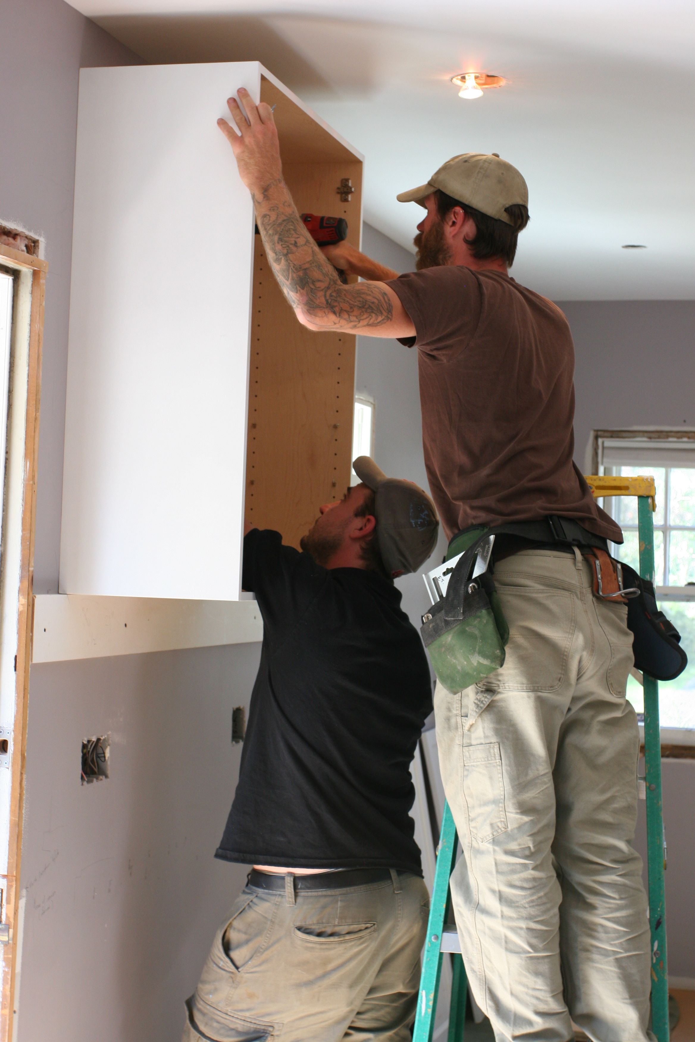 Attaching the cabinet to the blocking that they put in the walls in anticipation of cabinet needs. Smart fellas.