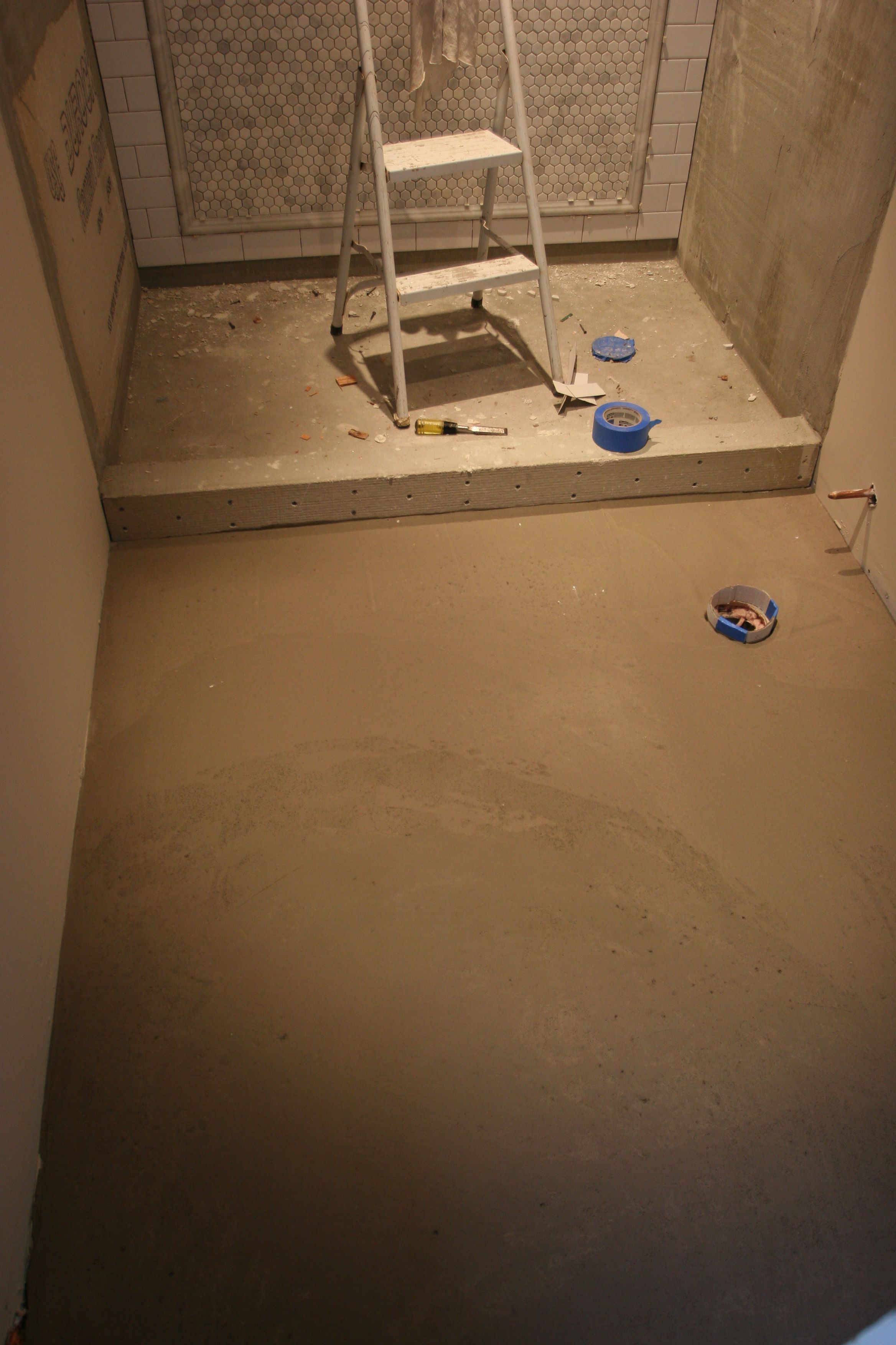 Self-leveling material poured to create a solid, flat base for our master bath floor. Awesome.