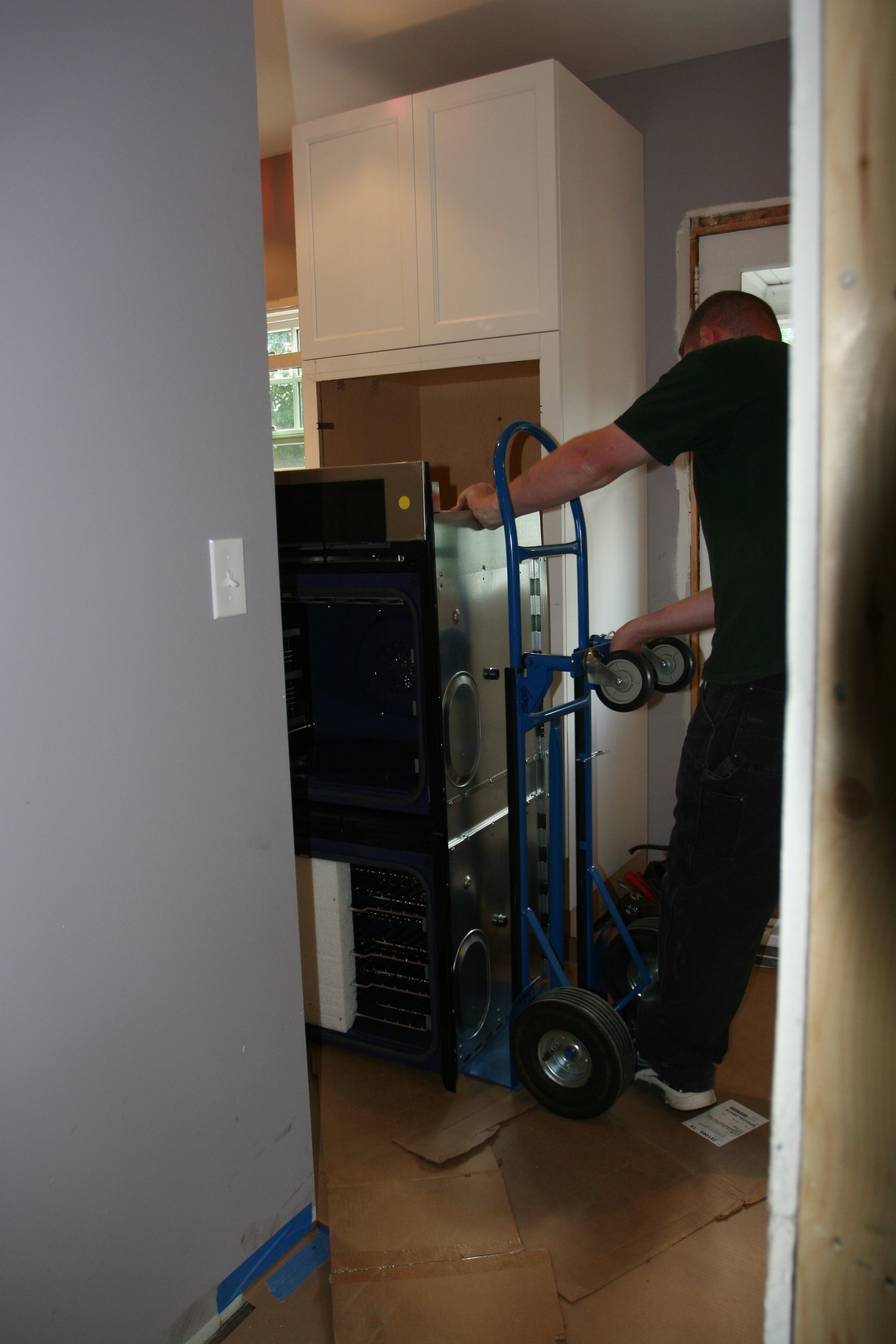 Brad setting up for wall oven install. (This was before Dave and Brad figured out that the cabinet needed some shoring up to be an effective (read: safe) place to mount a 300+ lb. appliance with moving parts.
