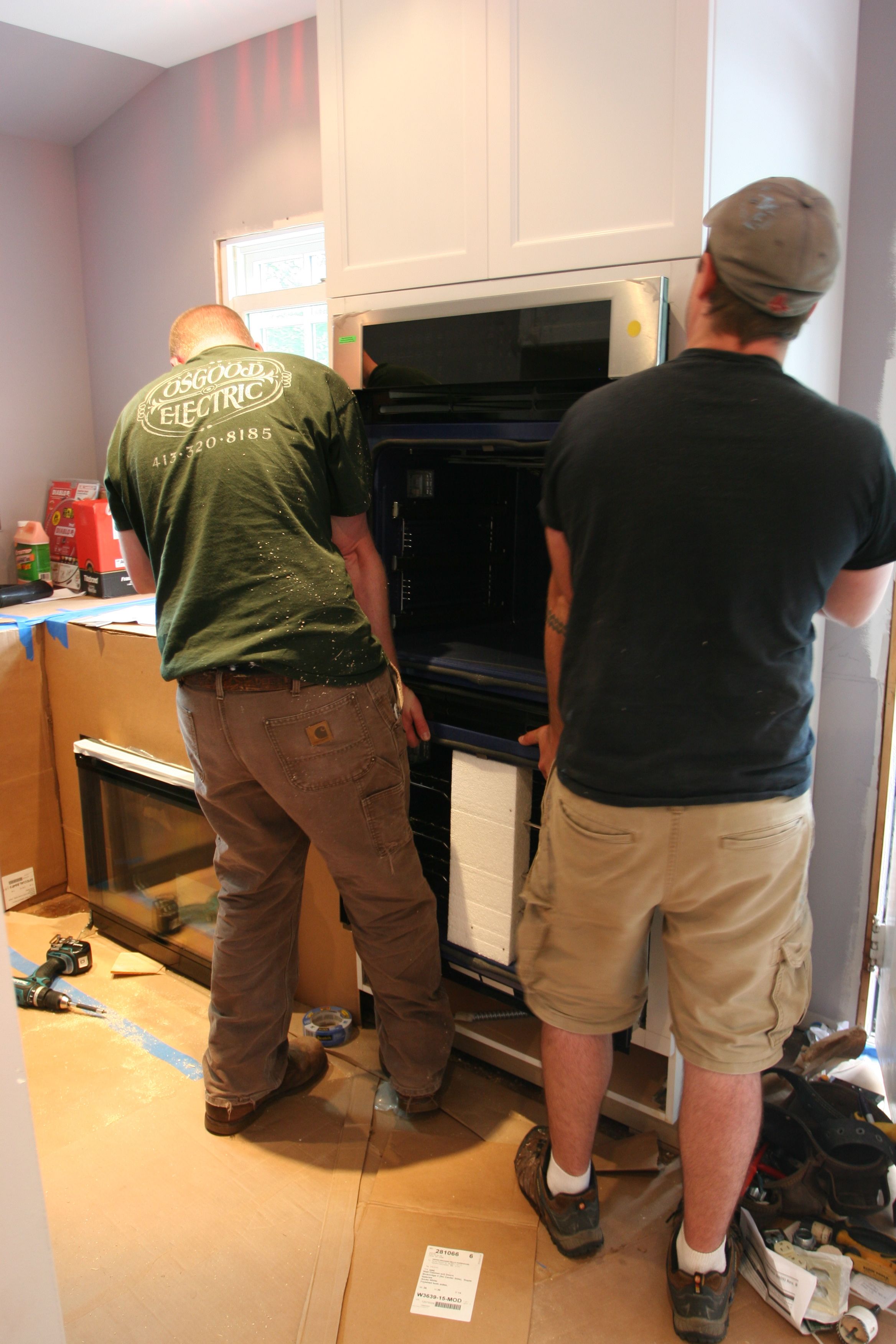 Adjusting the ovens into place. (The guys look mighty good here, right?)