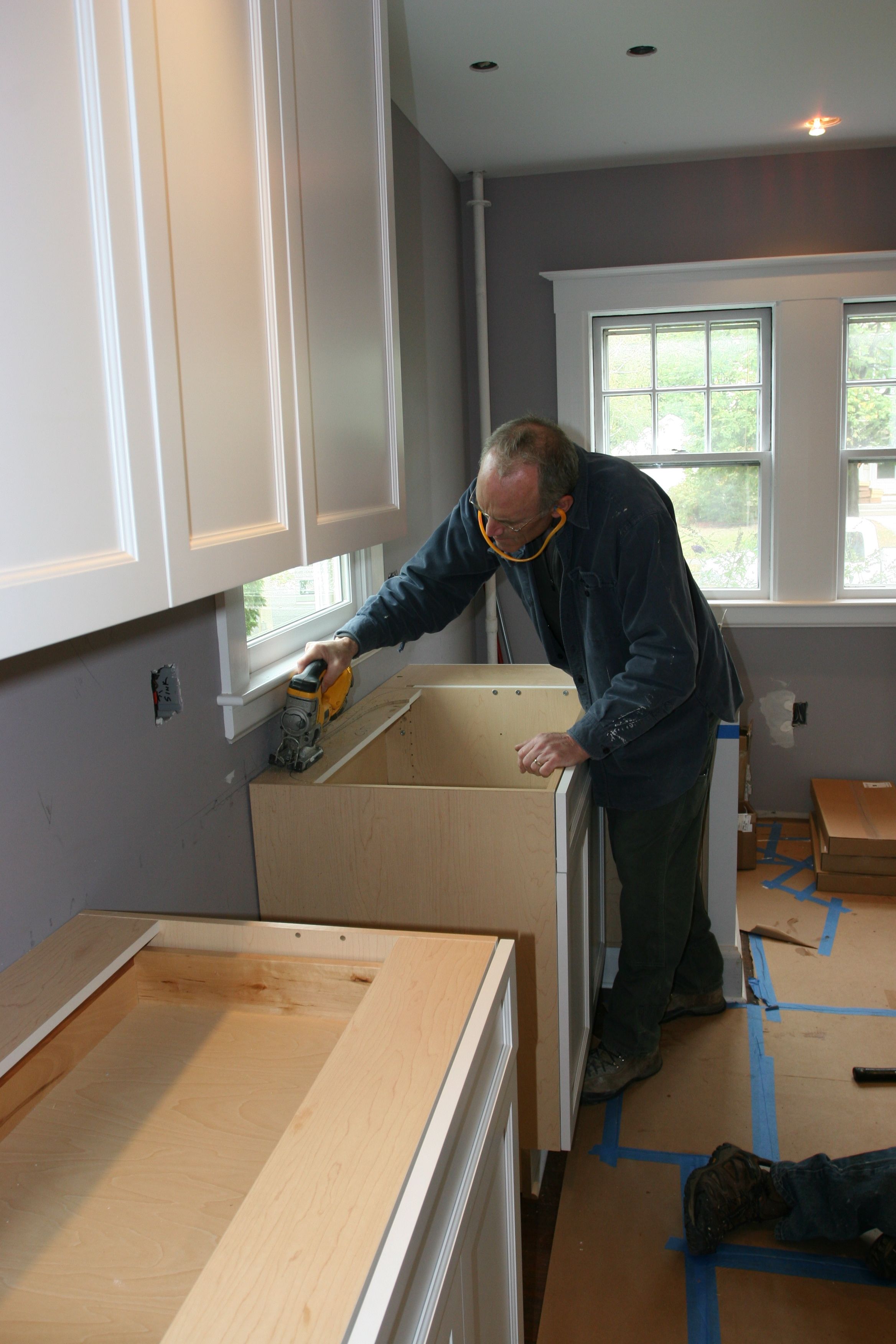 Tom cutting out the part of the cabinet that will interfere with the sink basin.