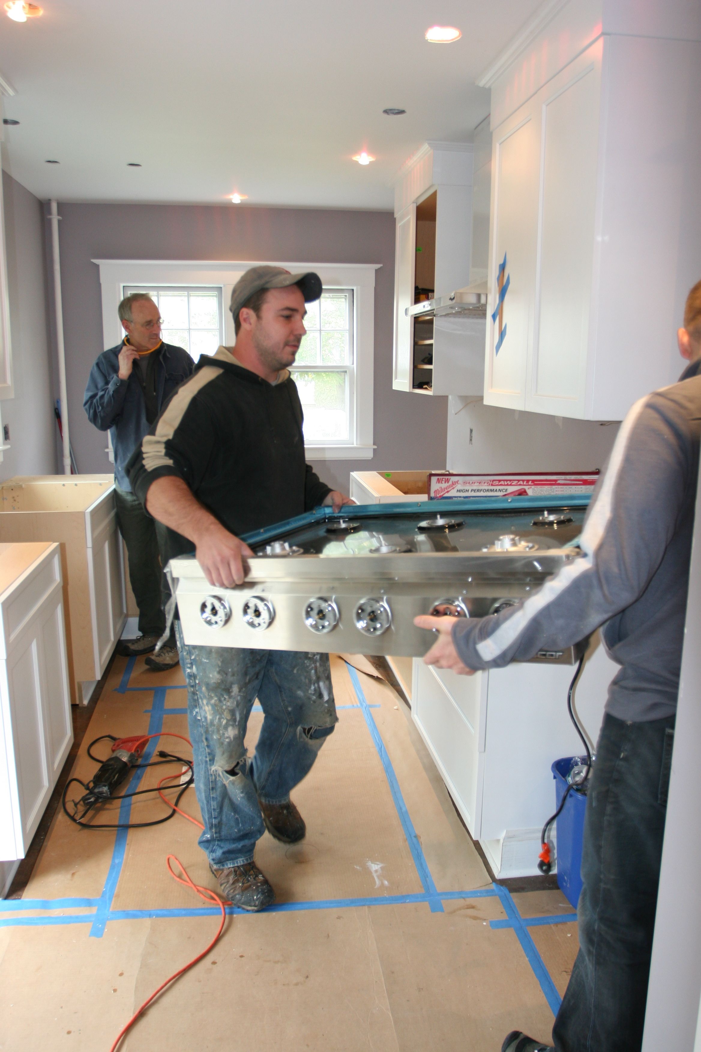 Jeff and Dave moving the appliances out of the way so they won't get damaged (or be in the way for the install).