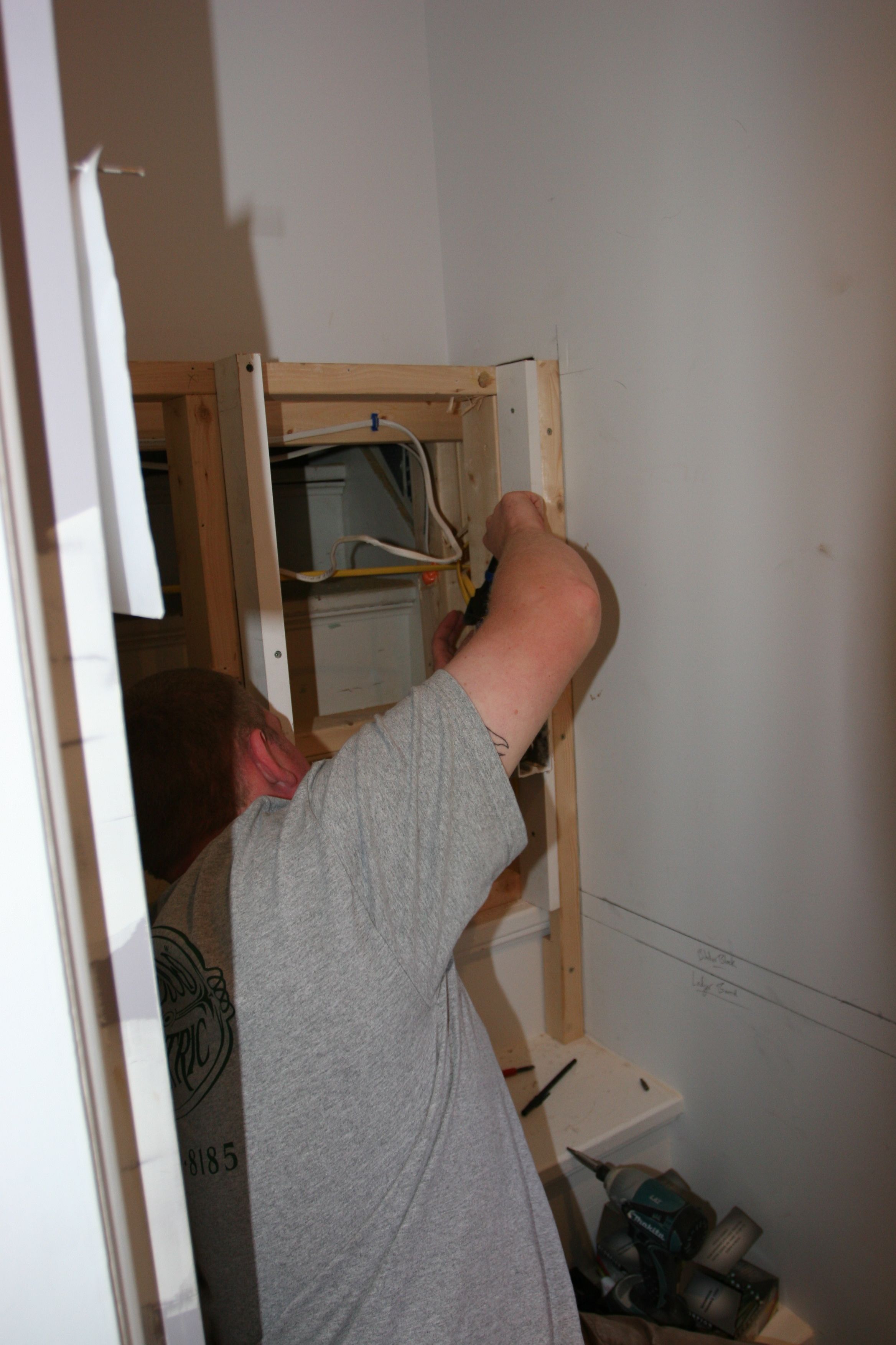 Brad inching the outlets and wires forward to the correct position.