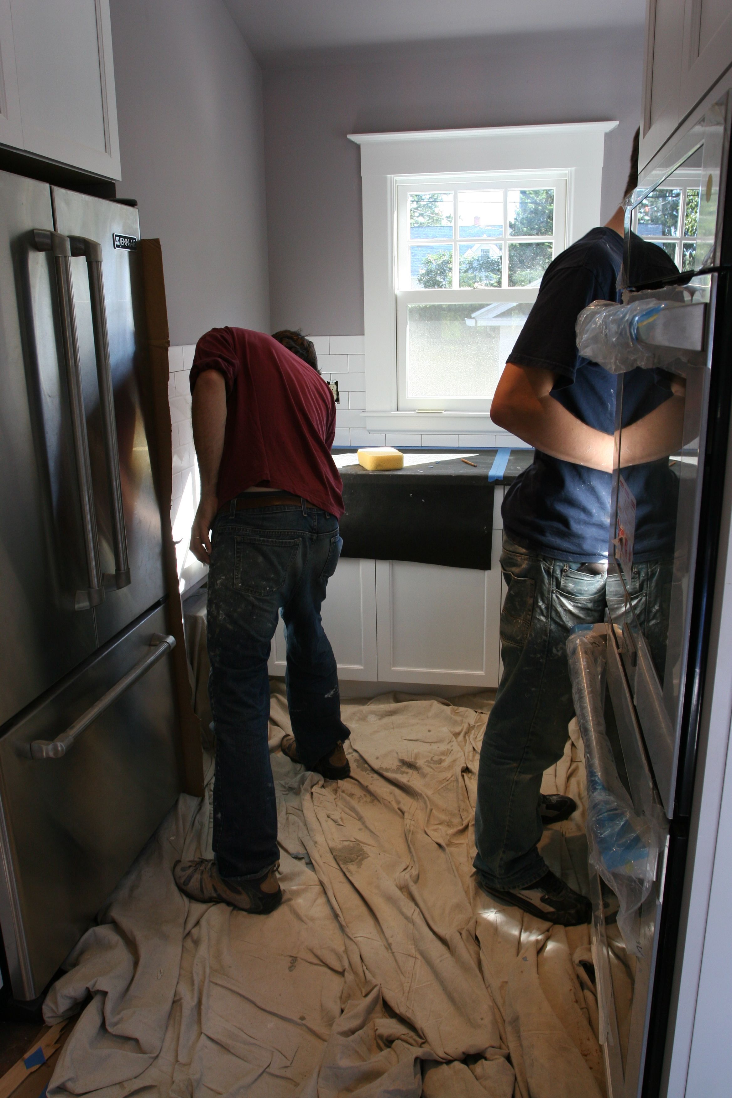 The boys grouting away. (THEY started singing "Let's get it grouted in here" a la The Black Eyed Peas. They, not me.)