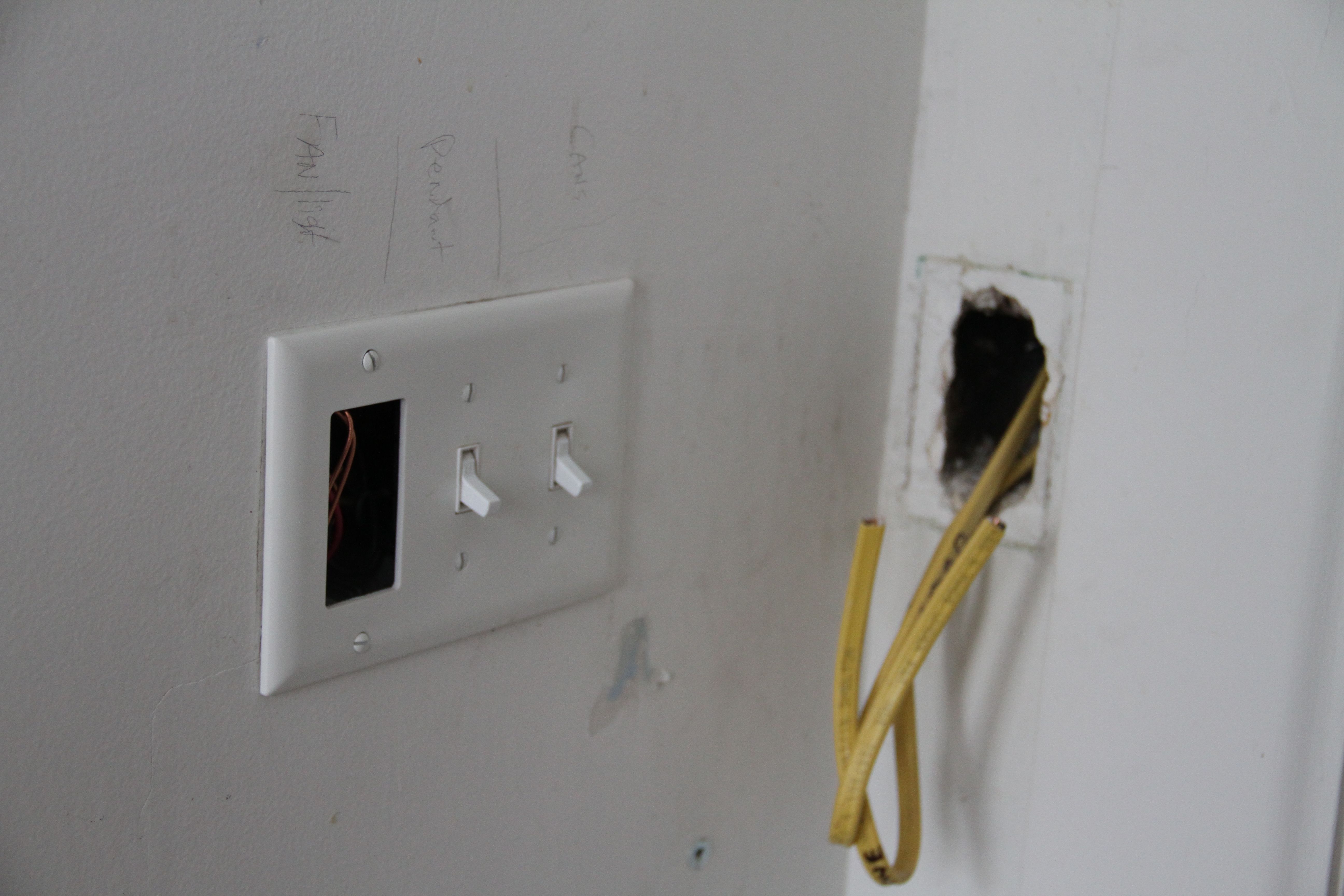 We were able to use some existing holes in the walls for the thermostat for the floor mat (where those yellow wires are). The light switch plate will house a new fan switch, as well as two dimmers for general lighting, and a decorative pendant.