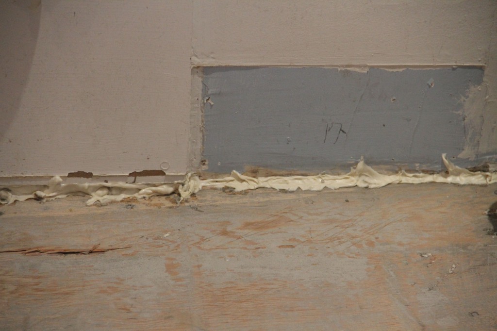Spray foam was used to fill up the gap left at the bottom of the wall so that the floor leveler wouldn't just run down the interior of the house. Sneaky trick.
