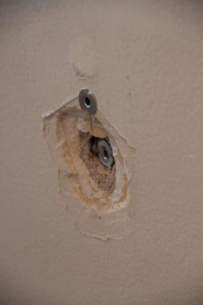 This is where Jeff and I hit a snag. We needed to try to remove some old anchors from our plaster wall. It didn't work. We're going to have to cut them out. At least we'll get practice patching holes, right?