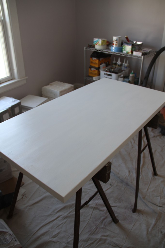 White primer on the butcher block counter. We couldn't afford stone (and the pricey installer that comes with it) so we went with a stable wood surface that our carpentry guys can easily work with.