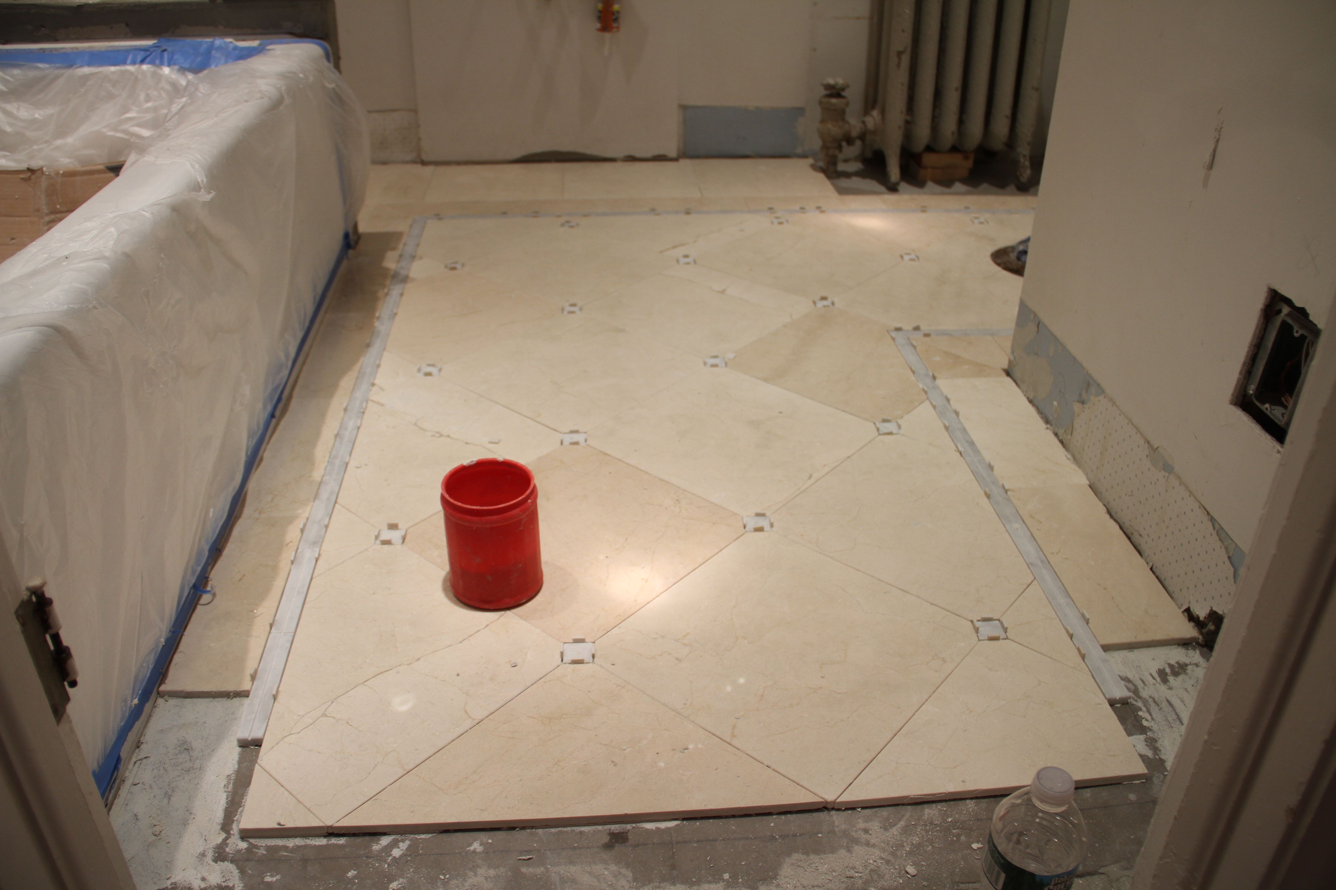 The last bits of the floor have to go in AFTER the threshold piece. But for now, we can protect the floor and walk on it. Woo hoo!