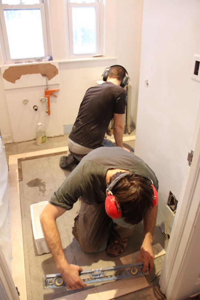 Finagling the non-straight doorway, non-flat wall behind the toilet, and the non-straight tub edge.