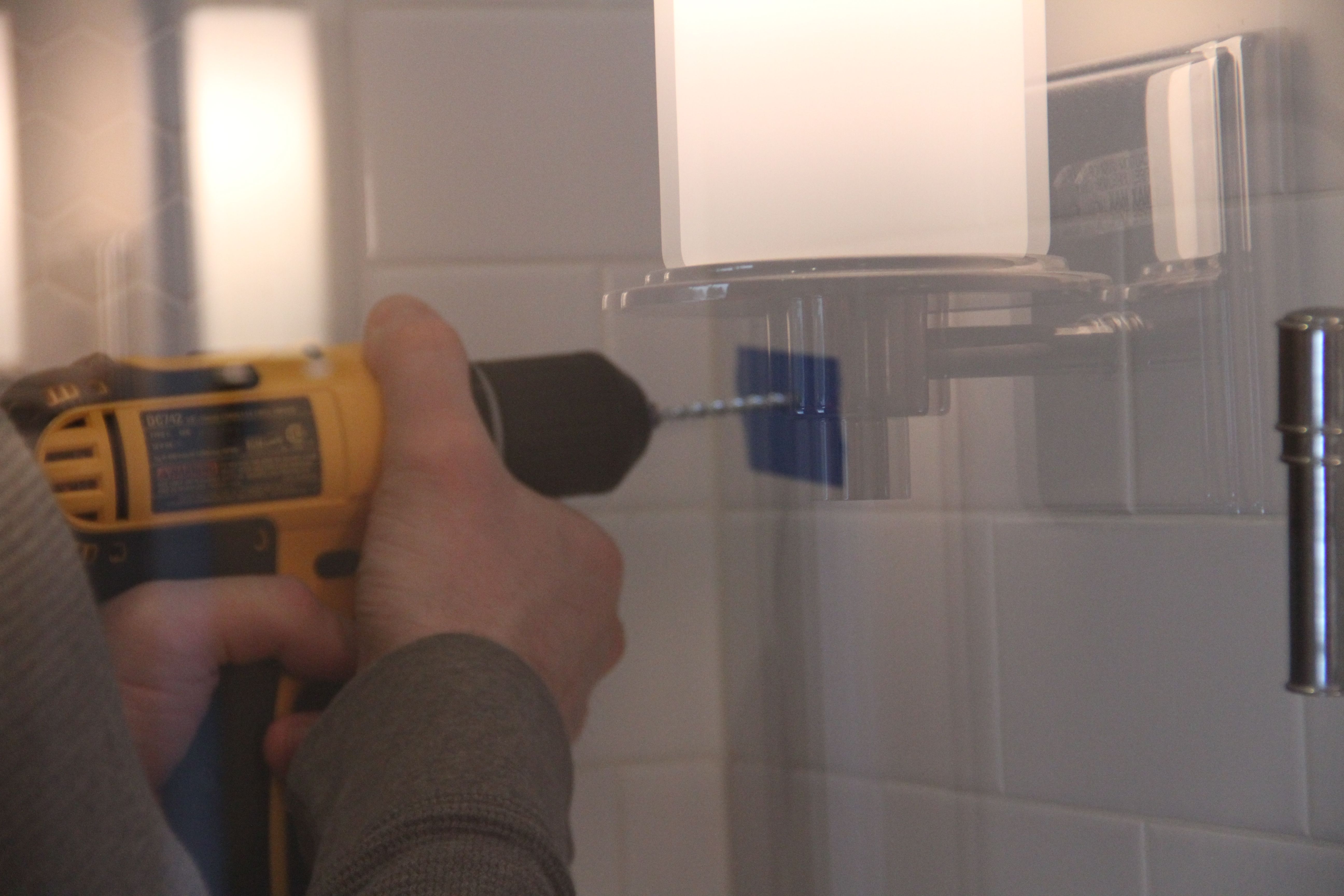 Jeff took the plunge and drilled into our shower wall. I was nervous, but tried not to let it show.