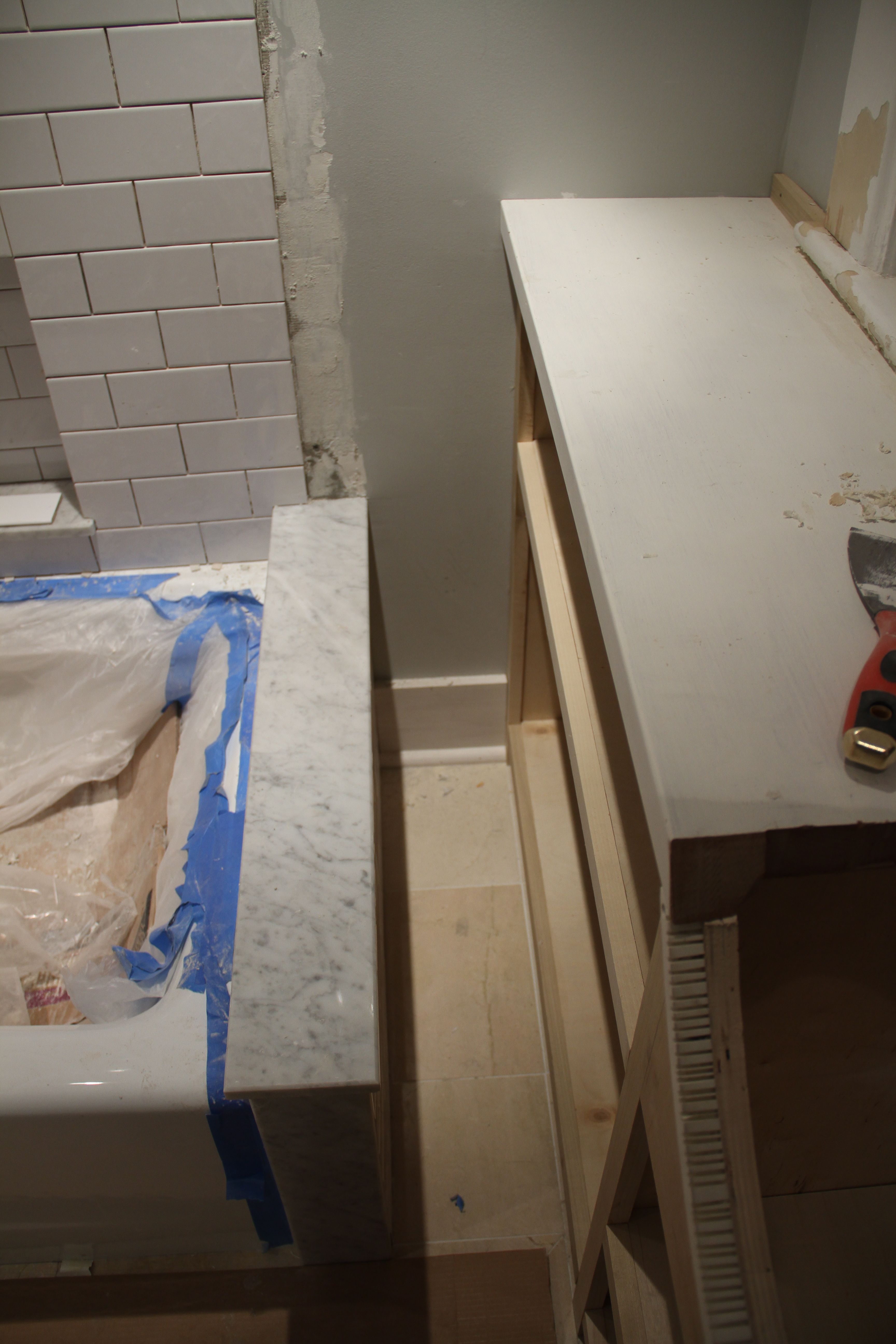 Even that little bit of wall needed baseboard. The shower curtain will fit nicely in that little slot.