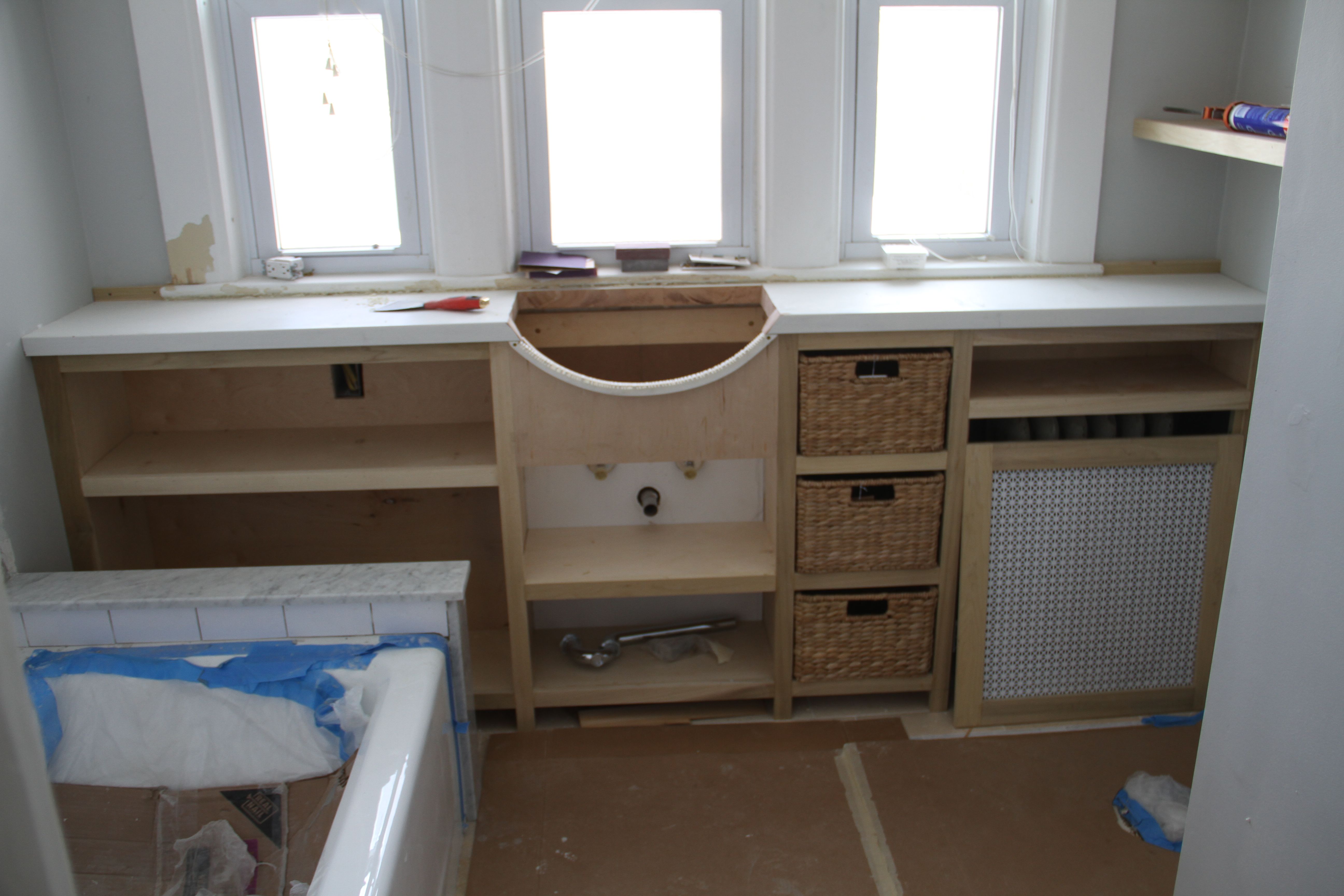 Here is the cabinet, sans sink, but with the baskets we bought for the cubbies.