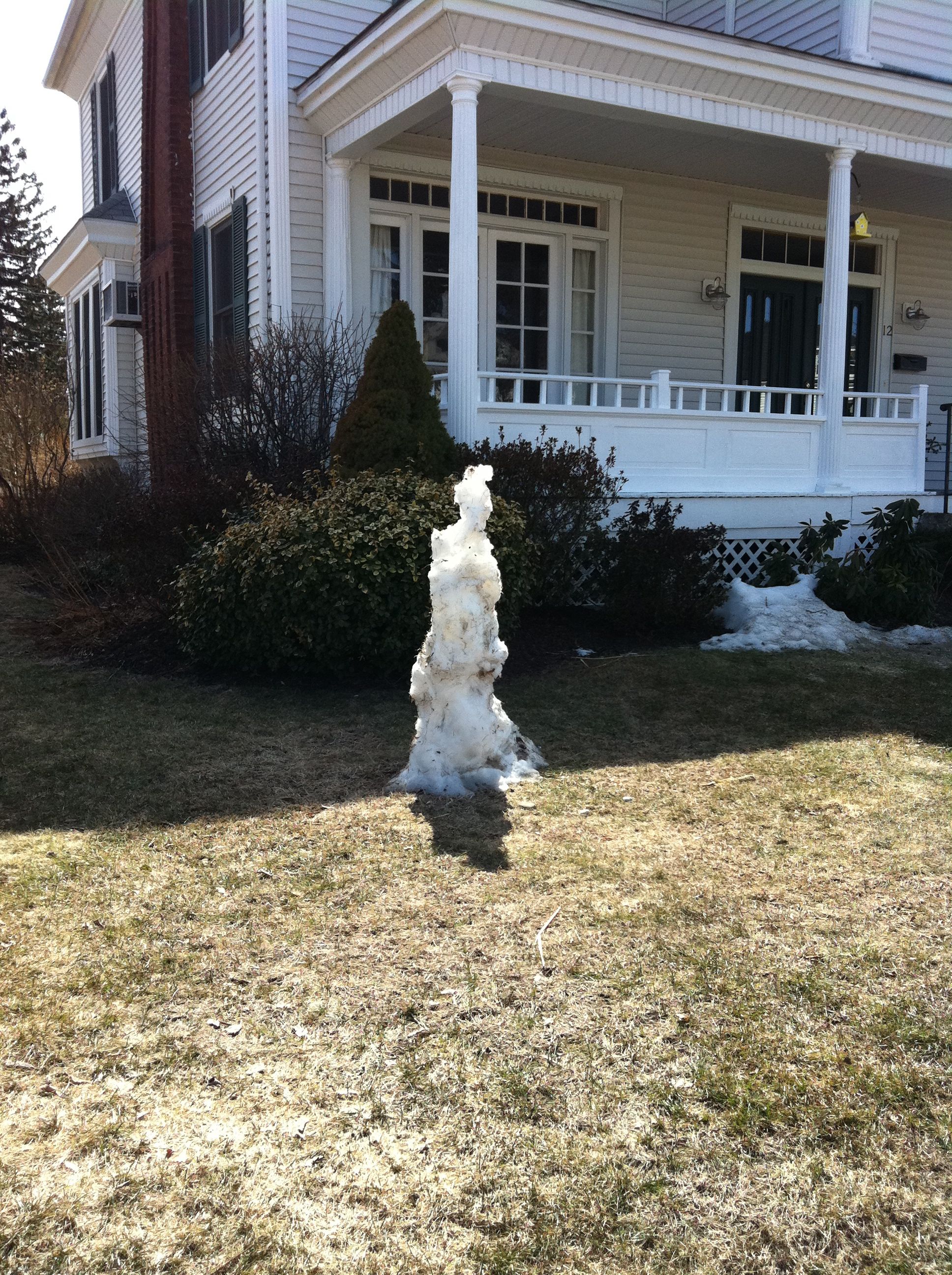 Our neighbor still has a snowman hanger-on. He's not gone yet, though he does look a little pitiful.