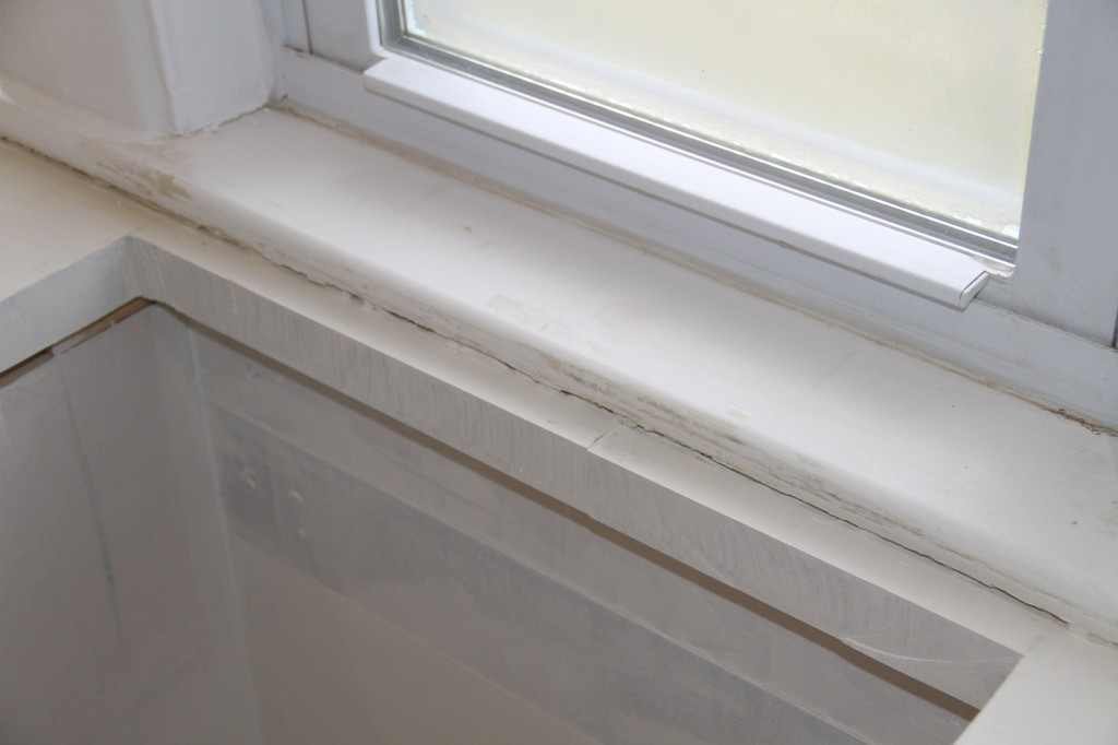 There is a gap beneath the windowsill that's been filled with spray foam insulation. Next comes a finishing bead of caulking, but I wanted to paint up the sill and ready-patch filler that I needed to smooth out some of the chips in the elderly paint.