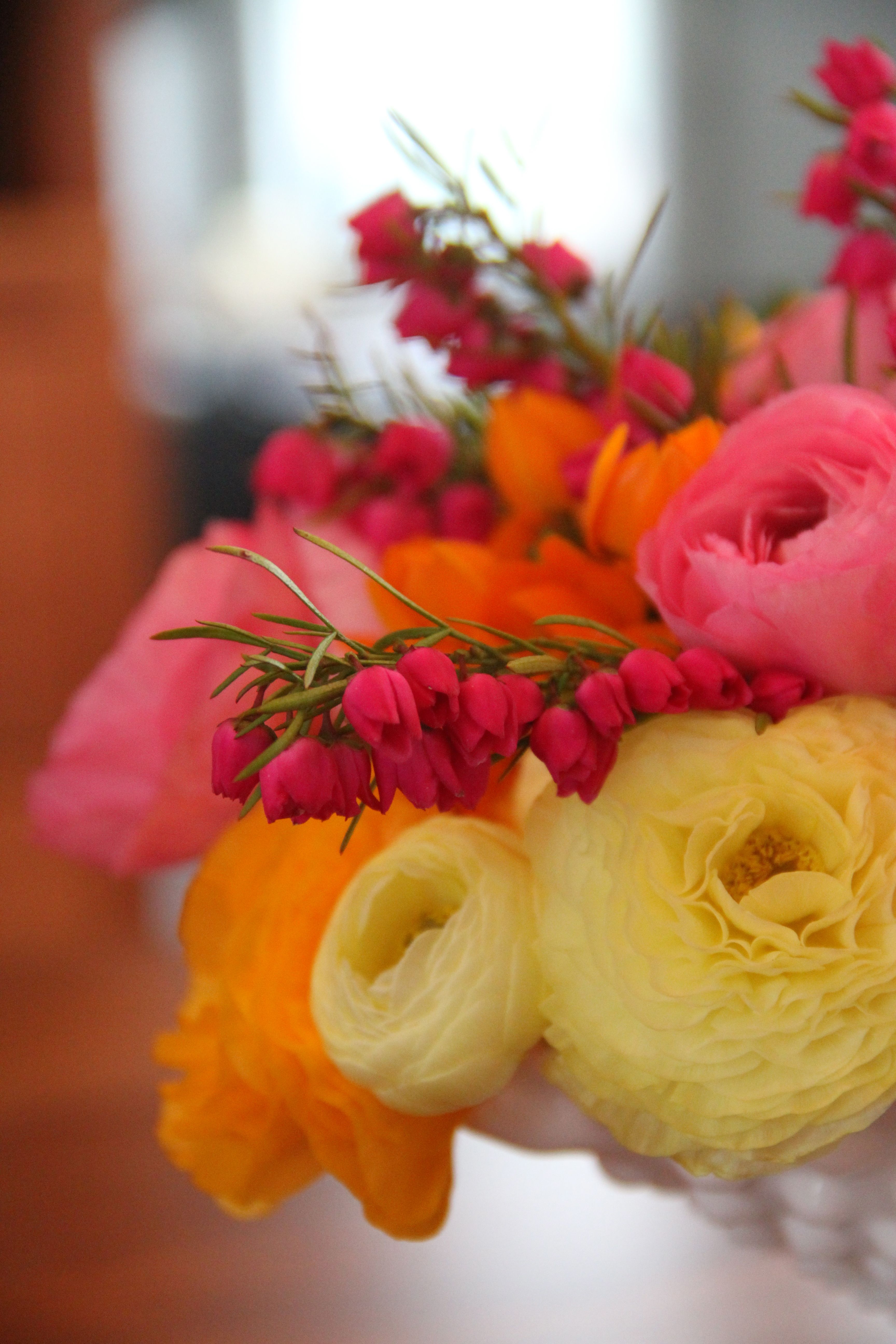 Ranunculus in yellow, orange and pink, with some other flower I can't recall adding a shot of hot pink. Edible, no?