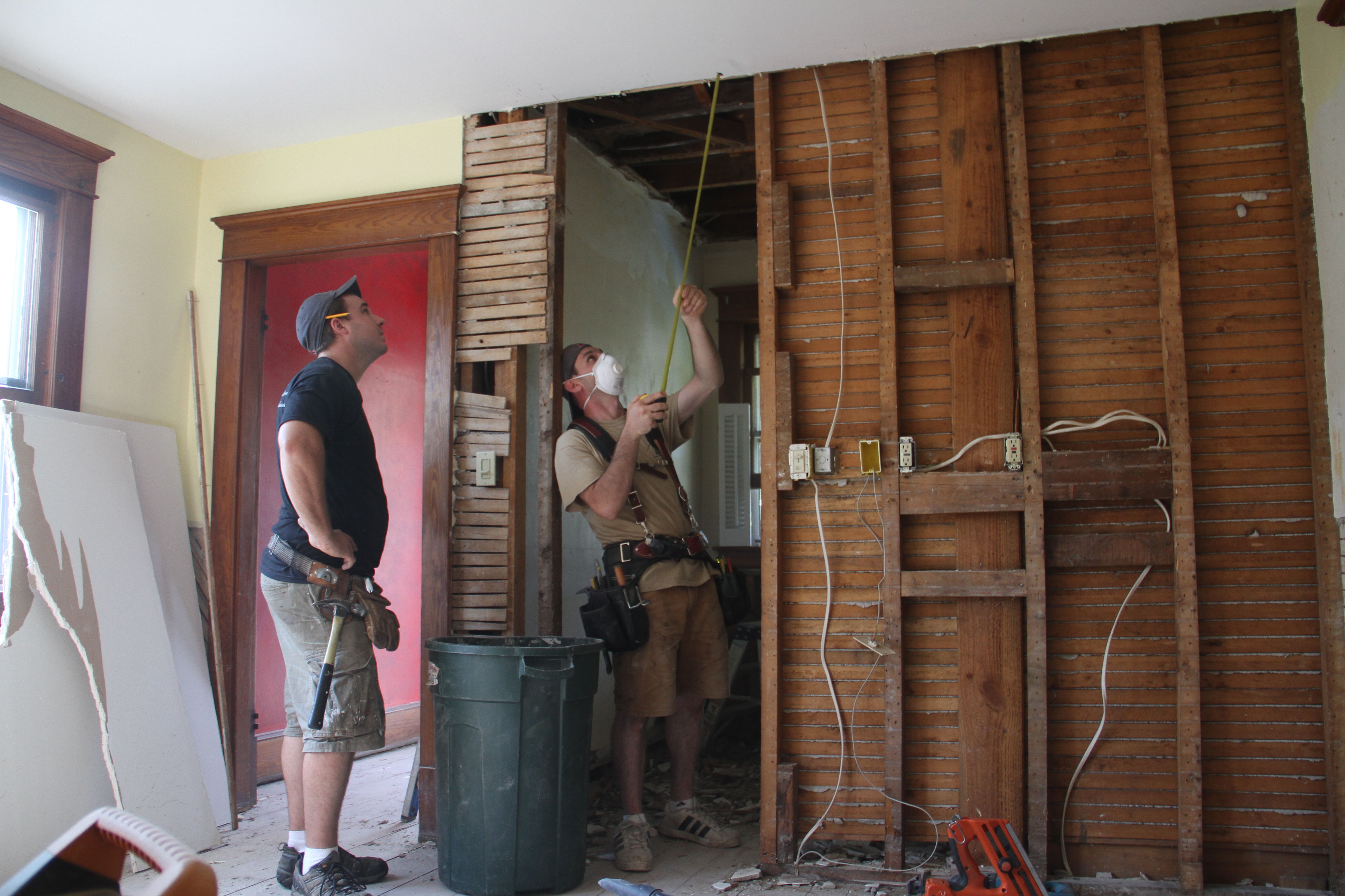 Dave and Jonas measuring the difference between ceiling heights in the adjacent spaces (formerly separated by a door).