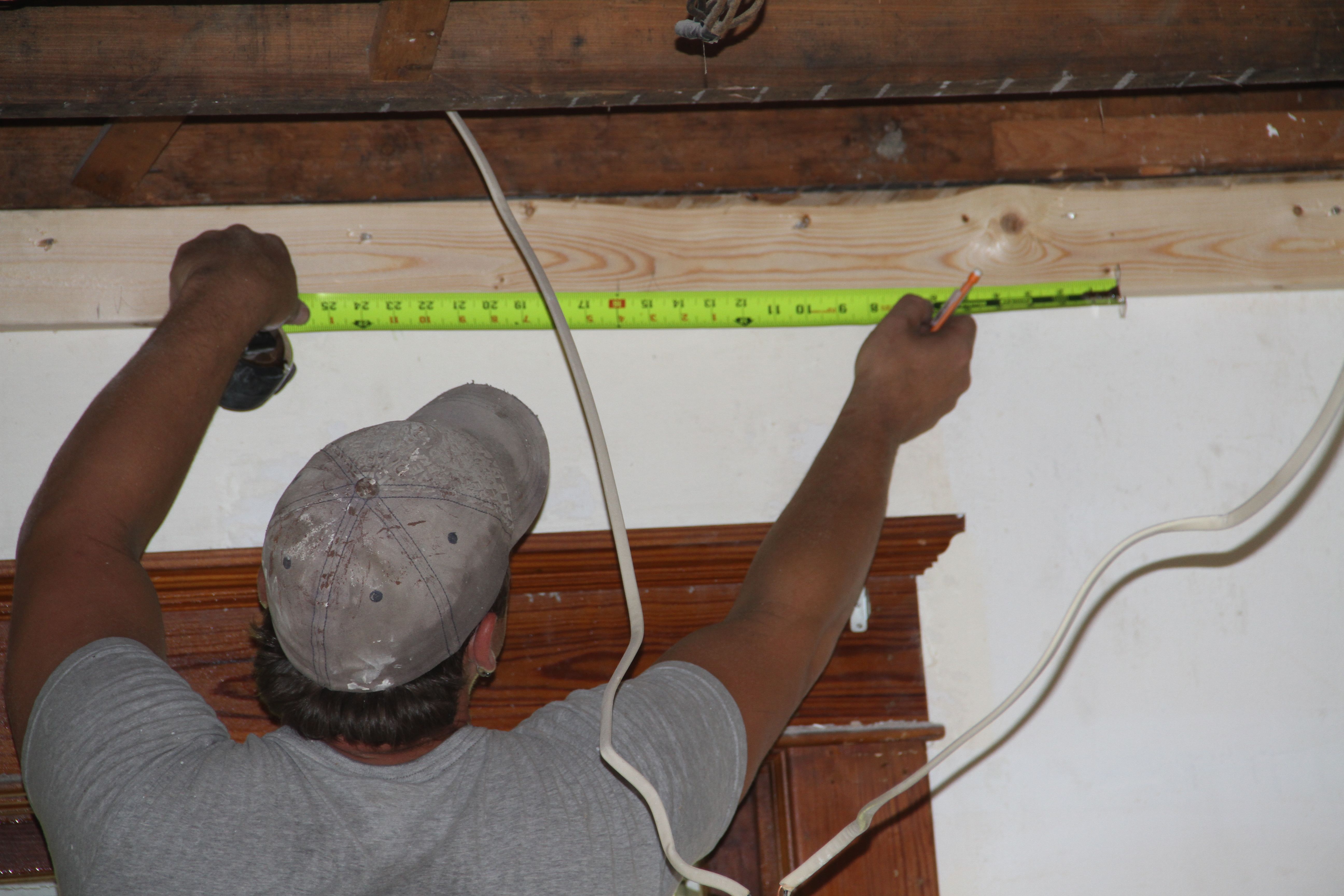 Brian measuring out the ceiling framing. These guys measure thrice, or maybe more to ensure the least waste possible.