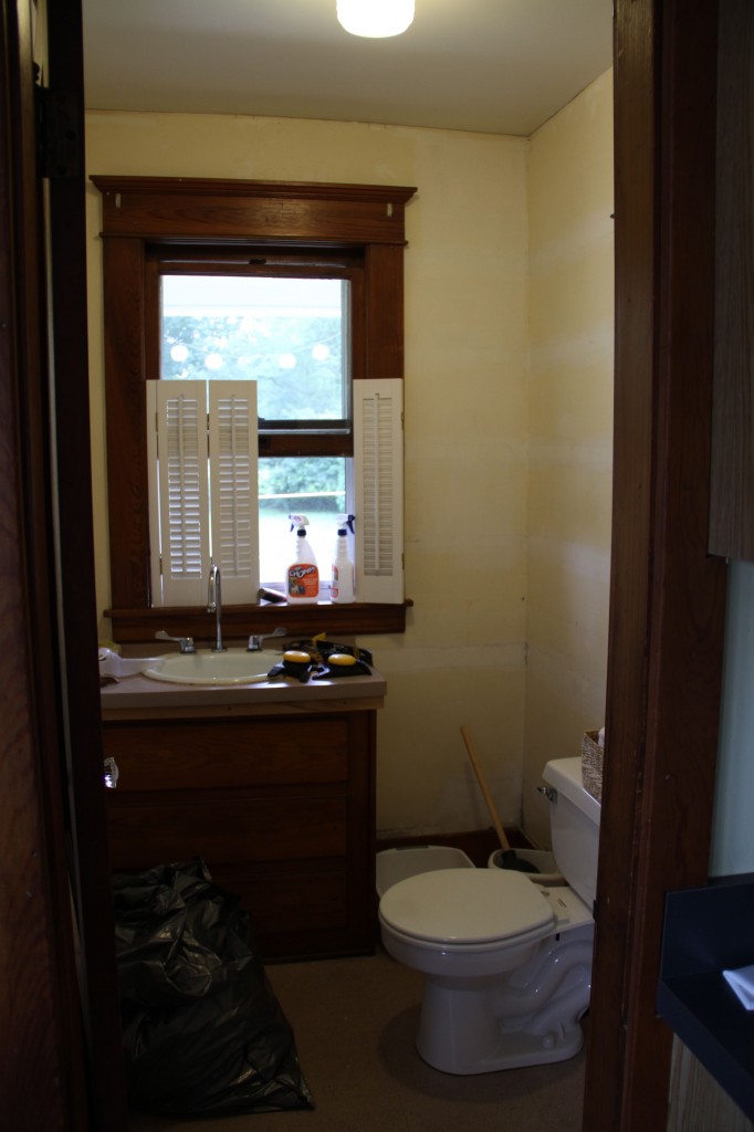 BEFORE: the powder room. The room had already been stripped of its wallpaper (think 80's) and non-authentic moldings by the homeowners.