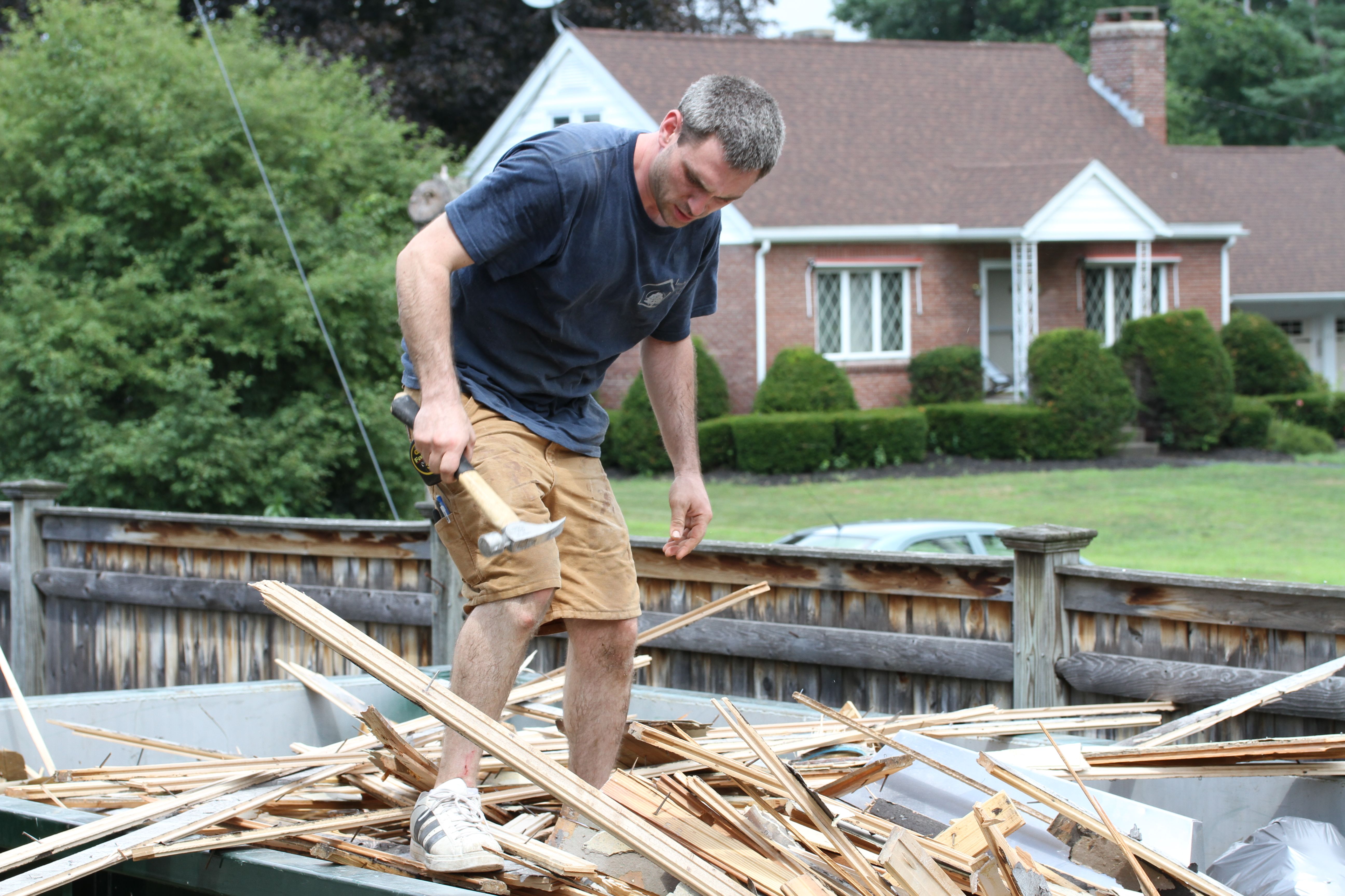 Jonas doing what you should NEVER do: walk on top of a pile of insecure lumber strewn with nails.