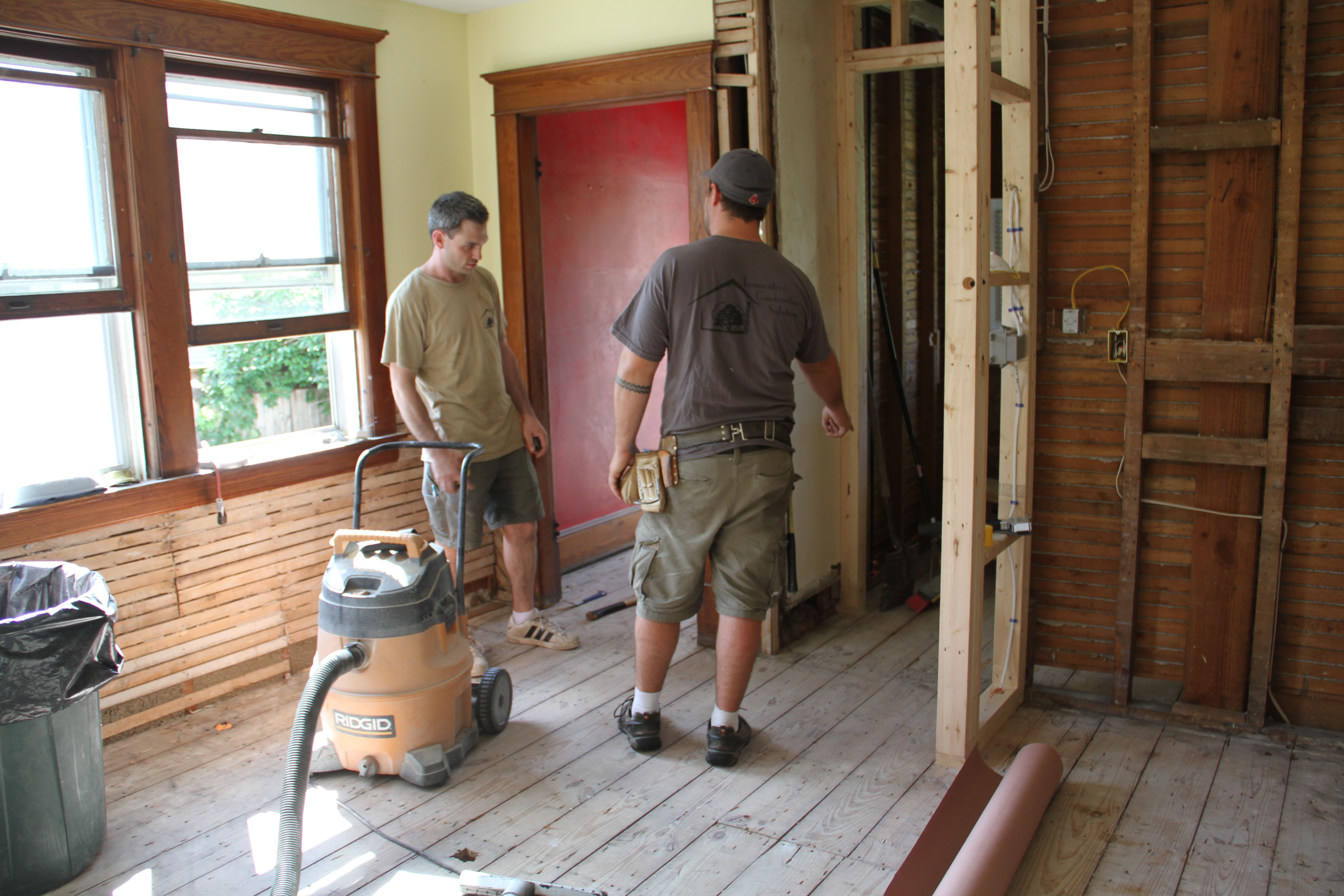 Jonas and Dave working out the best place to begin installing the flooring.