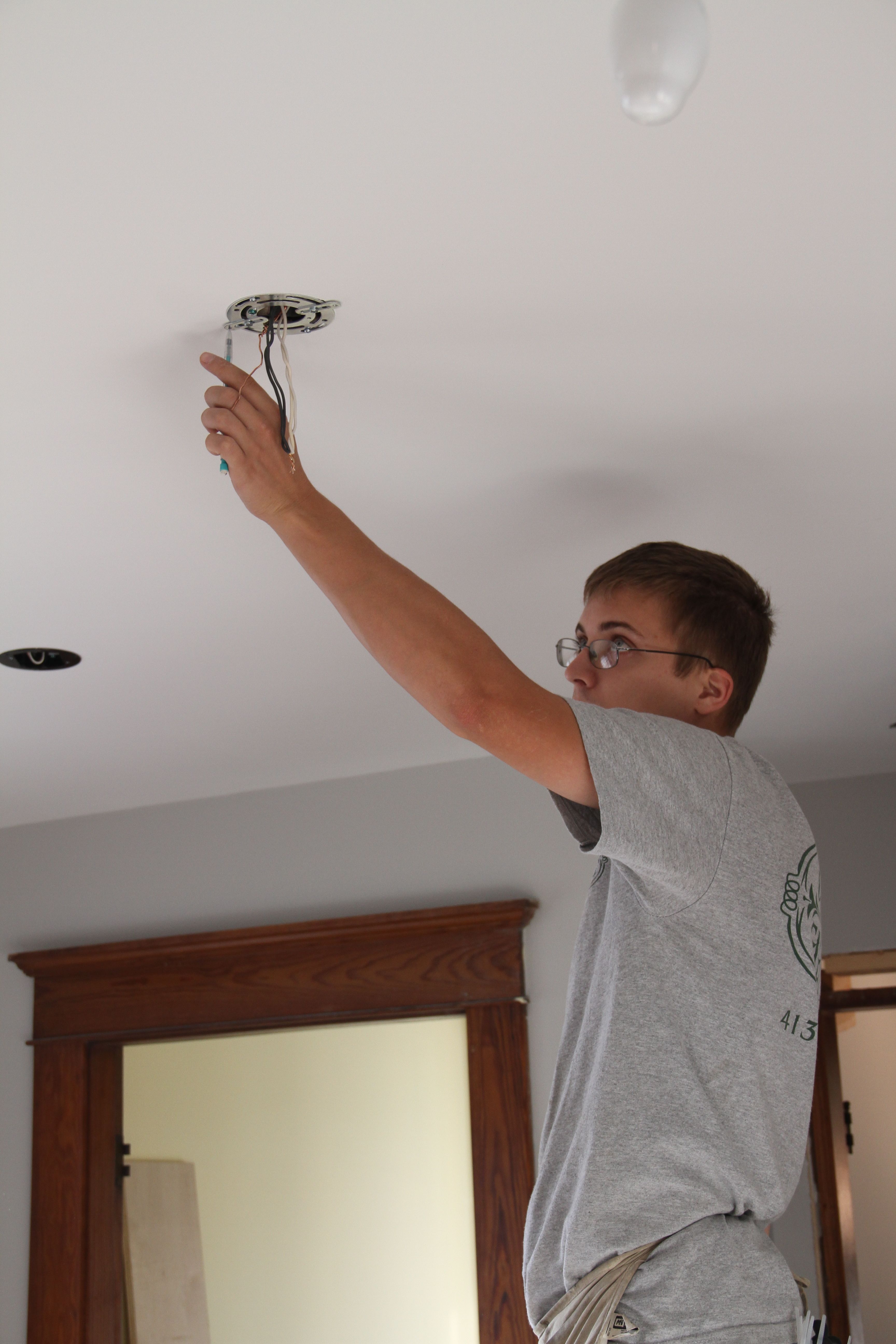 Eric working on installing the pendant fixtures.