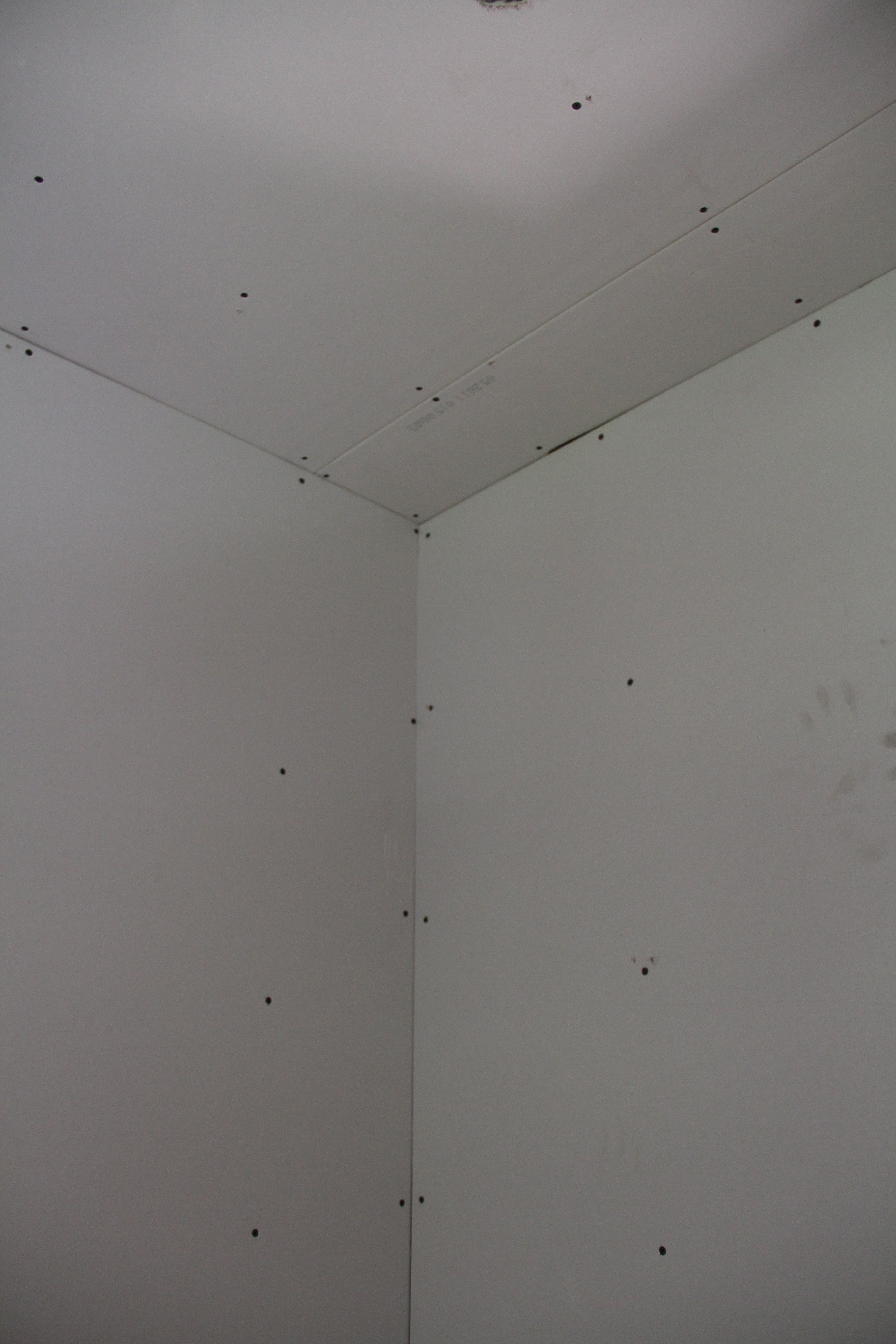 A bit of an optical illusion. But mainly it's just a shot of the tremendous amount of screws needed in proper drywall installation. All of those had to be covered with mud and sanded.
