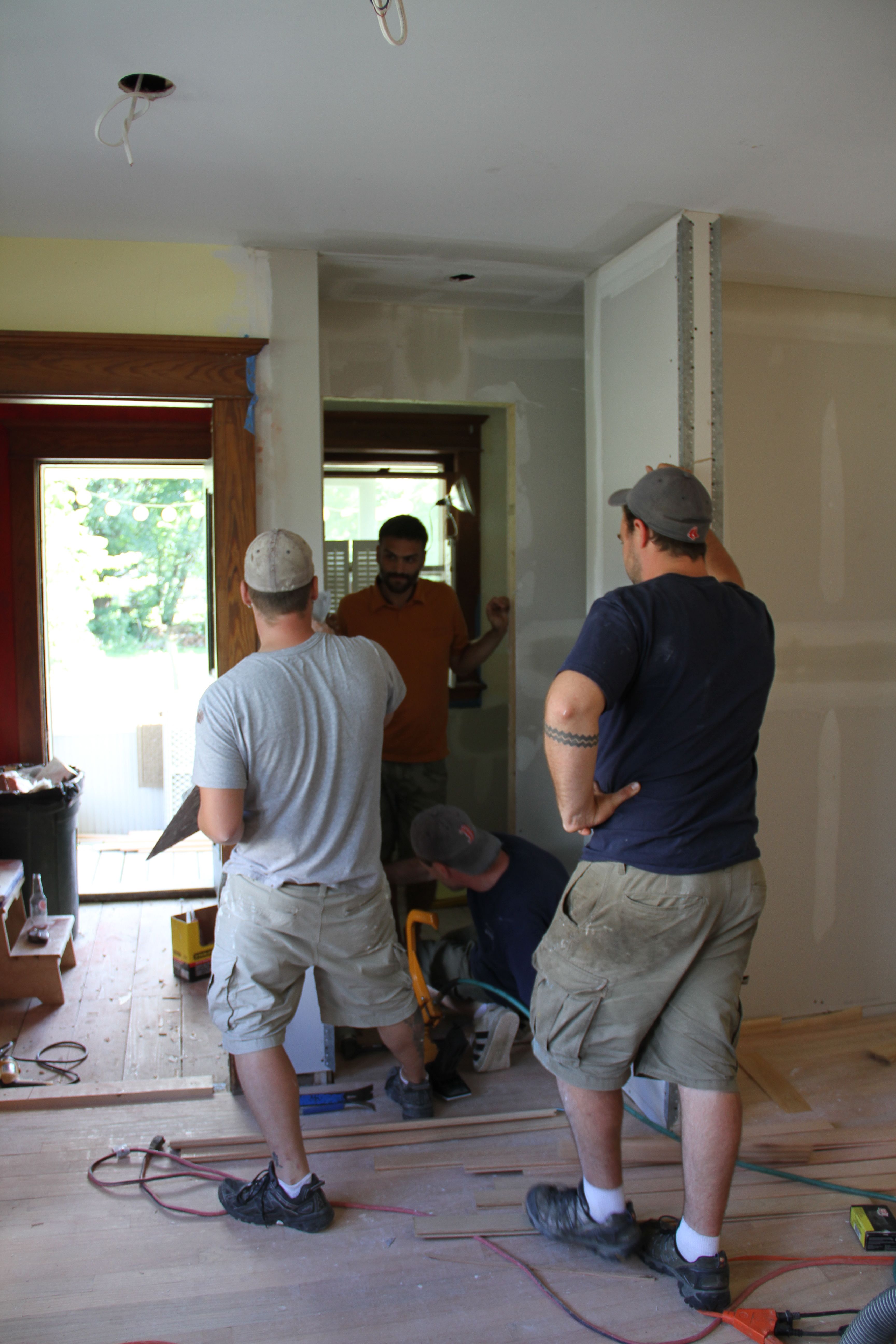 How many guys can we squeeze into a tiny space? There's Caleb inspecting the space for his tile requirements.