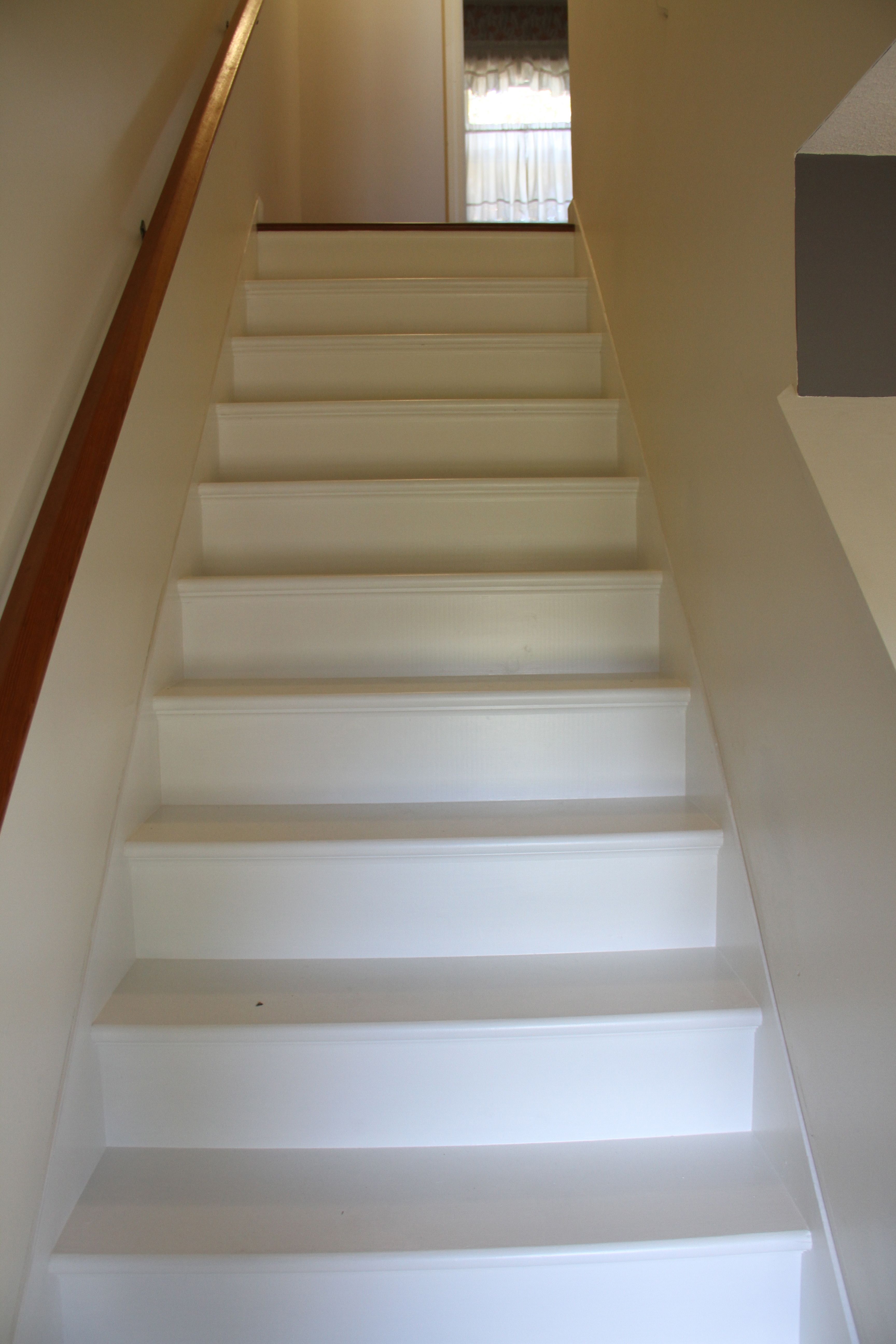 AFTER: These stairs were basically builder's stairs - stained, paint slopped on them, pitted, dented, nail and screw-holed - only ever intended to be covered in carpeting. Paint, patience and some love and attention were all they needed to get shined up again.