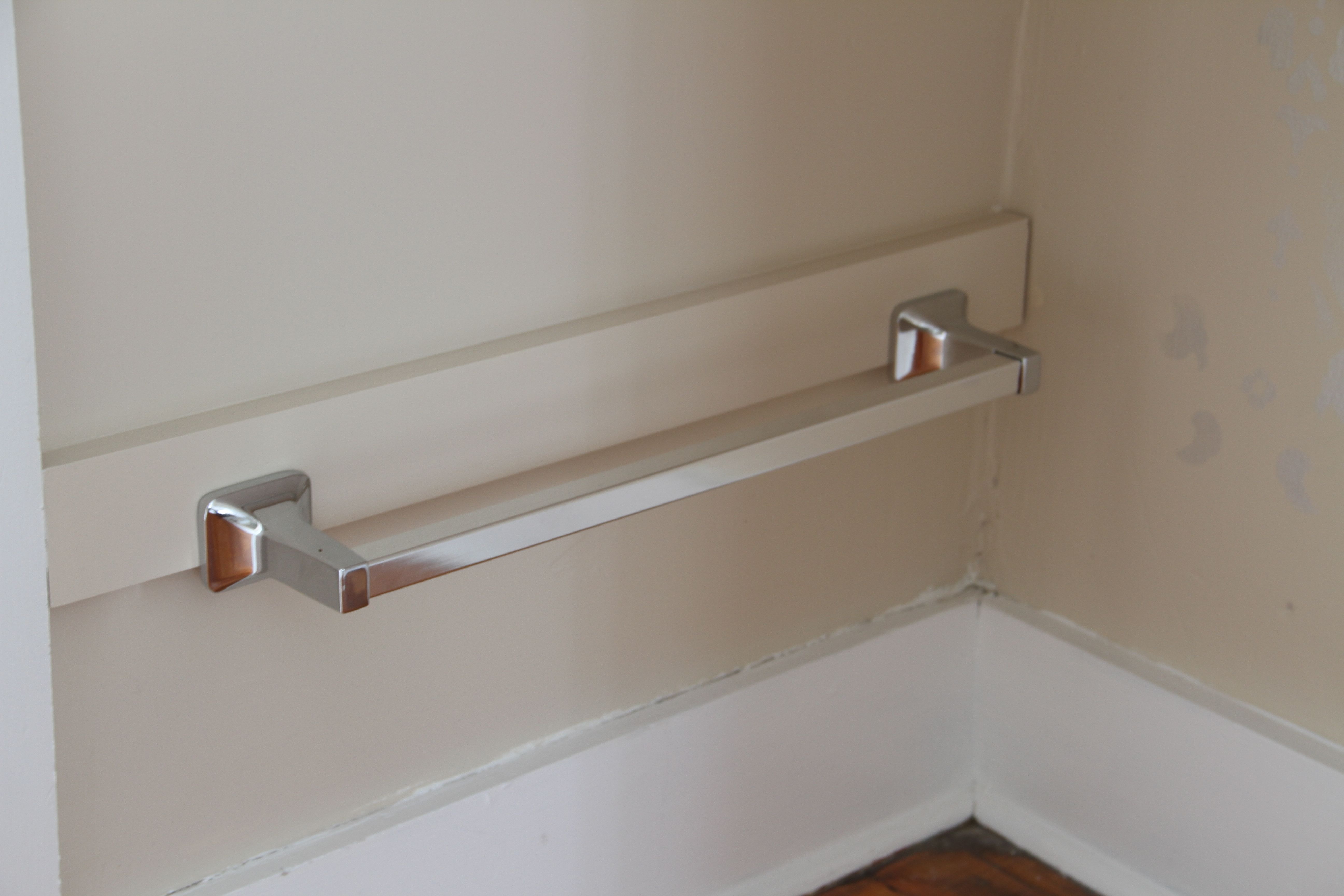 AFTER: The silver towel bars are for hanging the laundry baskets from. We needed something that would be about 3-1/2" total and the towel bar plus the wood was exactly right. Score!