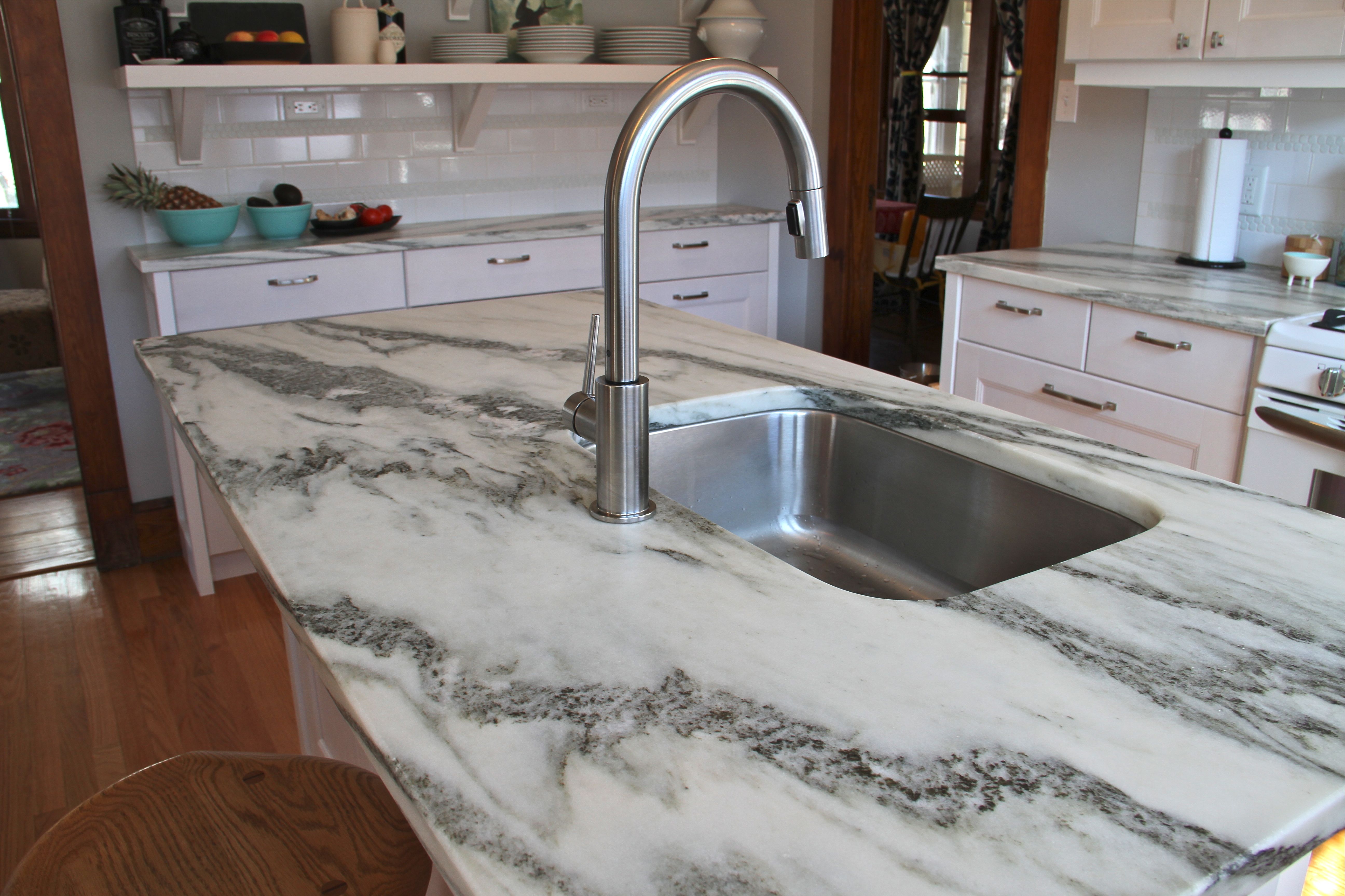 AFTER: While the kitchen isn't huge (approx 12'x12'), the island is still the hub of the space, housing the sink, dishwasher, seating and a lovely piece of Vermont Danby stone (which is a locally quarried marble from, you guessed right, Danby, VT).