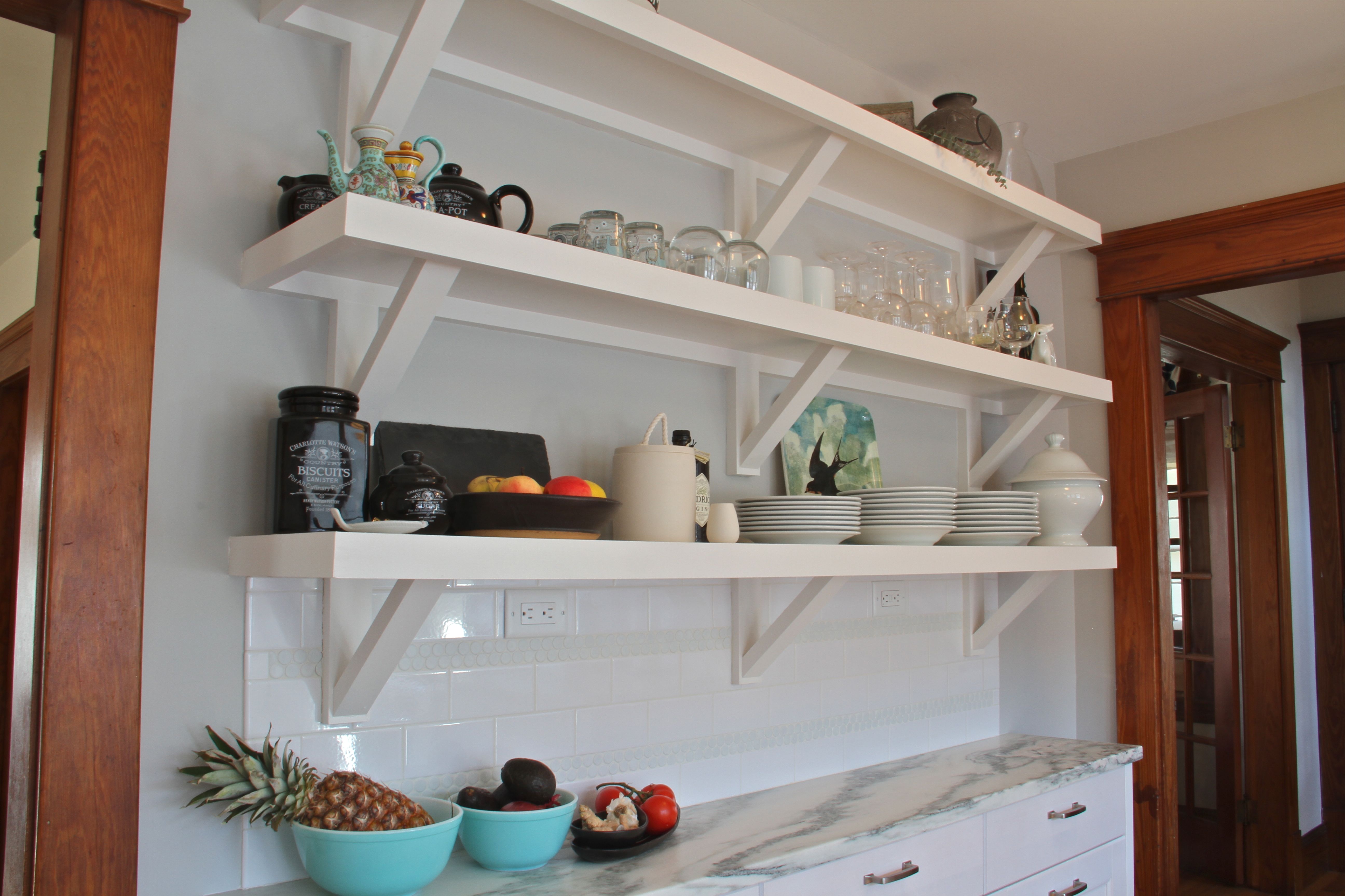 AFTER: The shelves AND the lower cabinets are about a foot deep, giving ample counterspace for a buffet, and ample upper-reach storage, while keeping the aisle open and easy to move through.