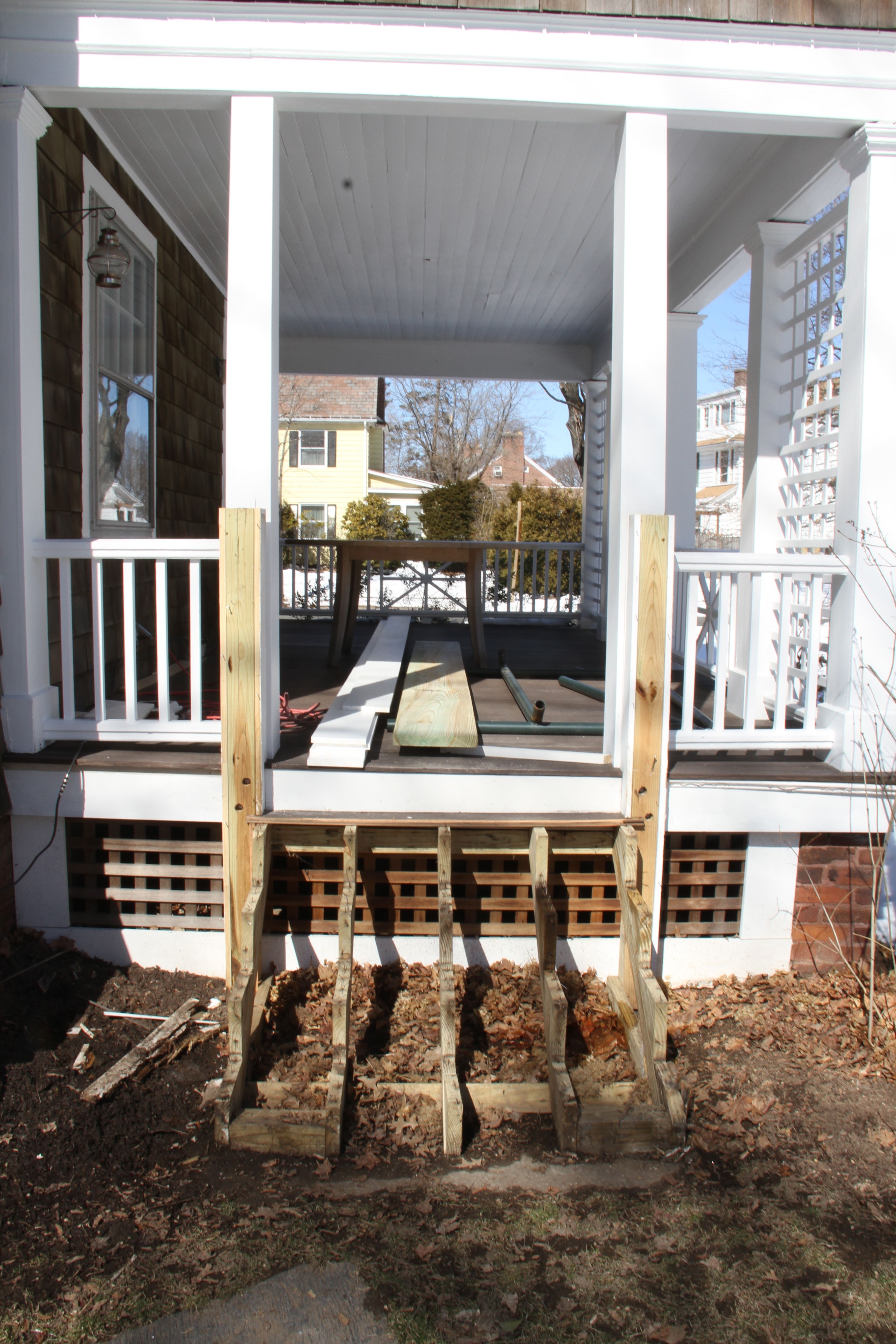 DURING/before: so, this porch we paid to have redone when we bought the house in 2006/7. The stairs were wrapped in pine (bad idea!) and were already rotting. Enter Team Carpentry.