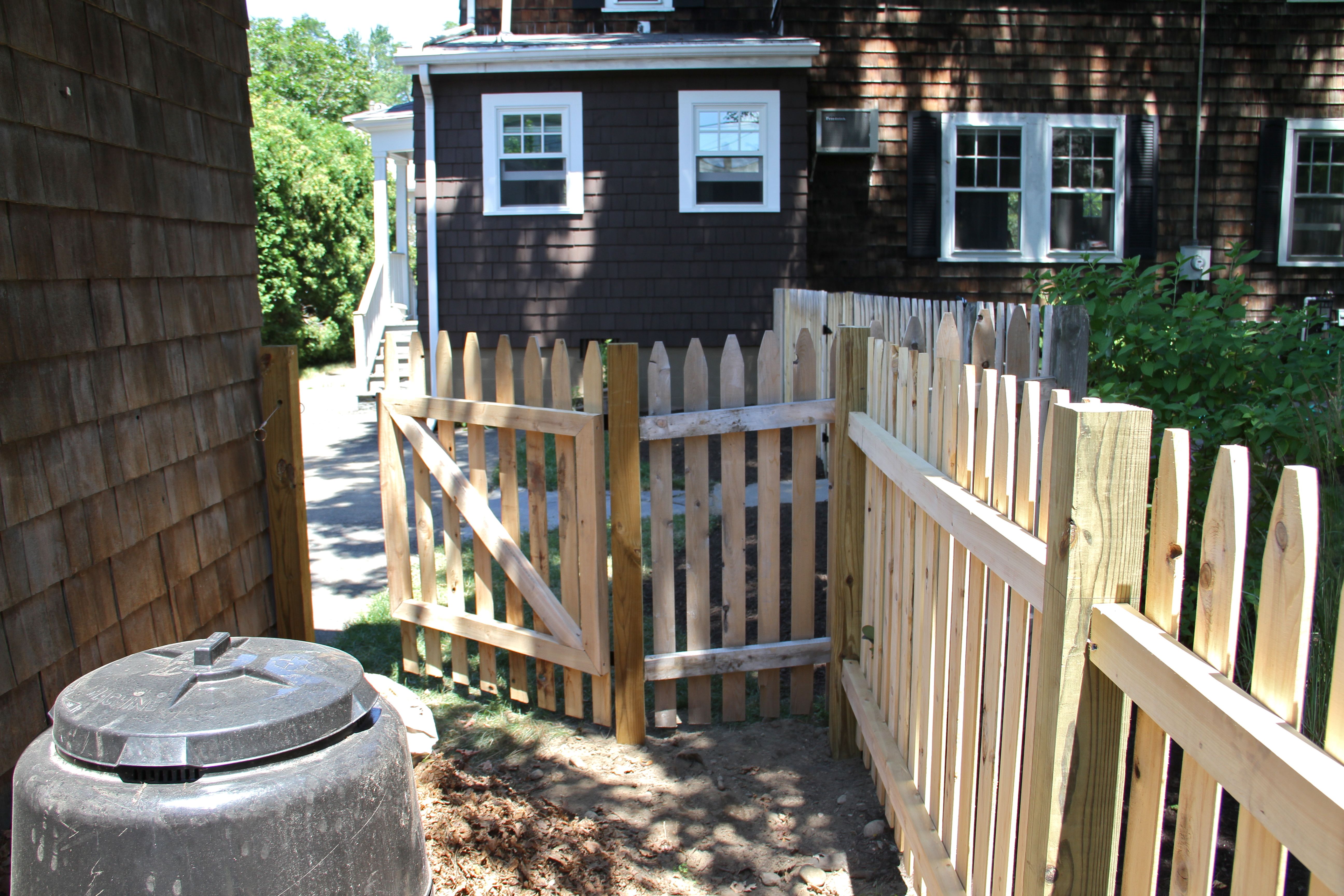 DURING: After we had the fencing installed we had to stain the fence and decide how to deal with the ground surface.