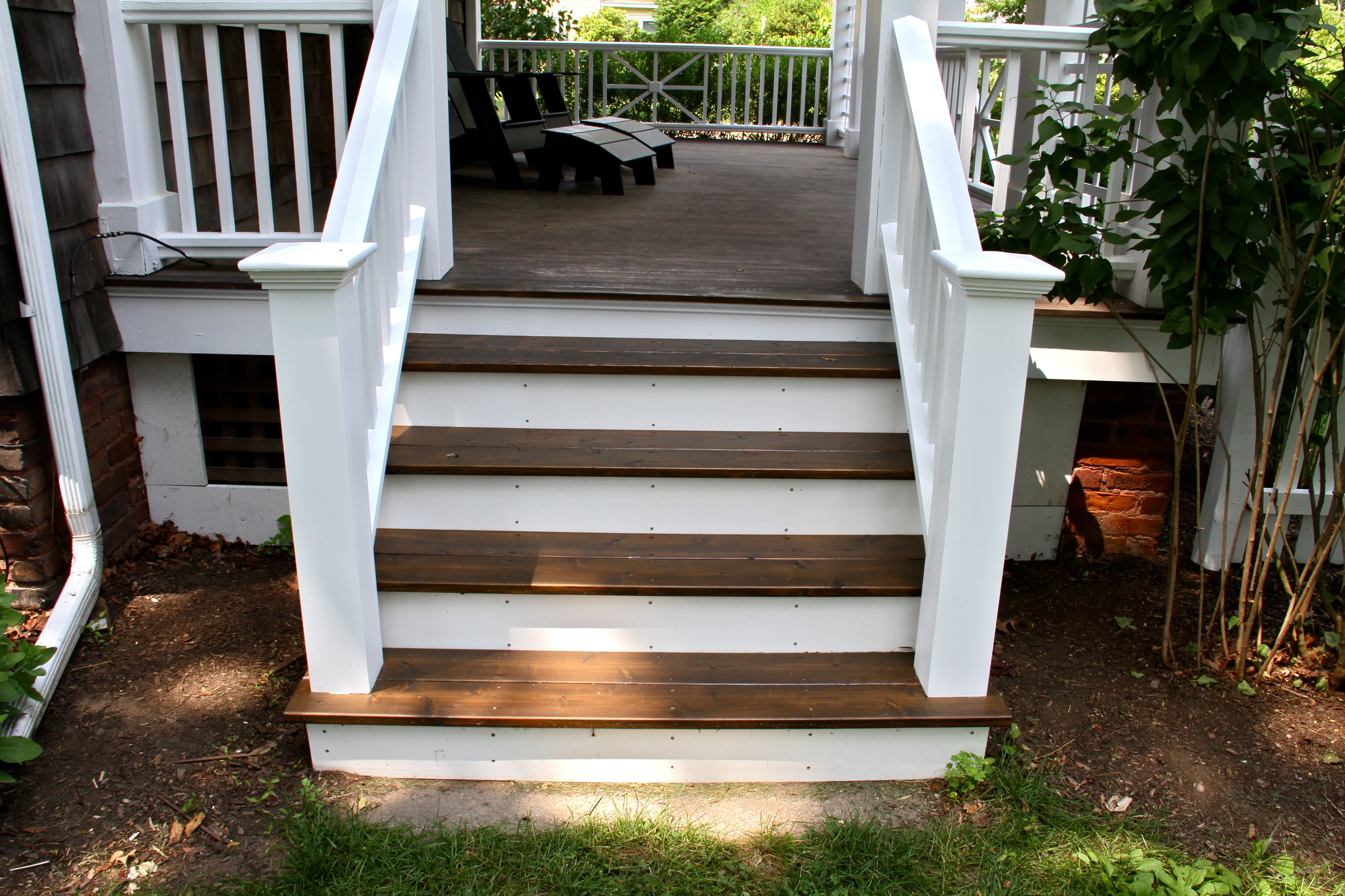 AFTER: The porch stairs, railings painted to match the rest of the trim and porch railings; treads re-stained with Cabot exterior oil-based stain in Burnt Hickory.
