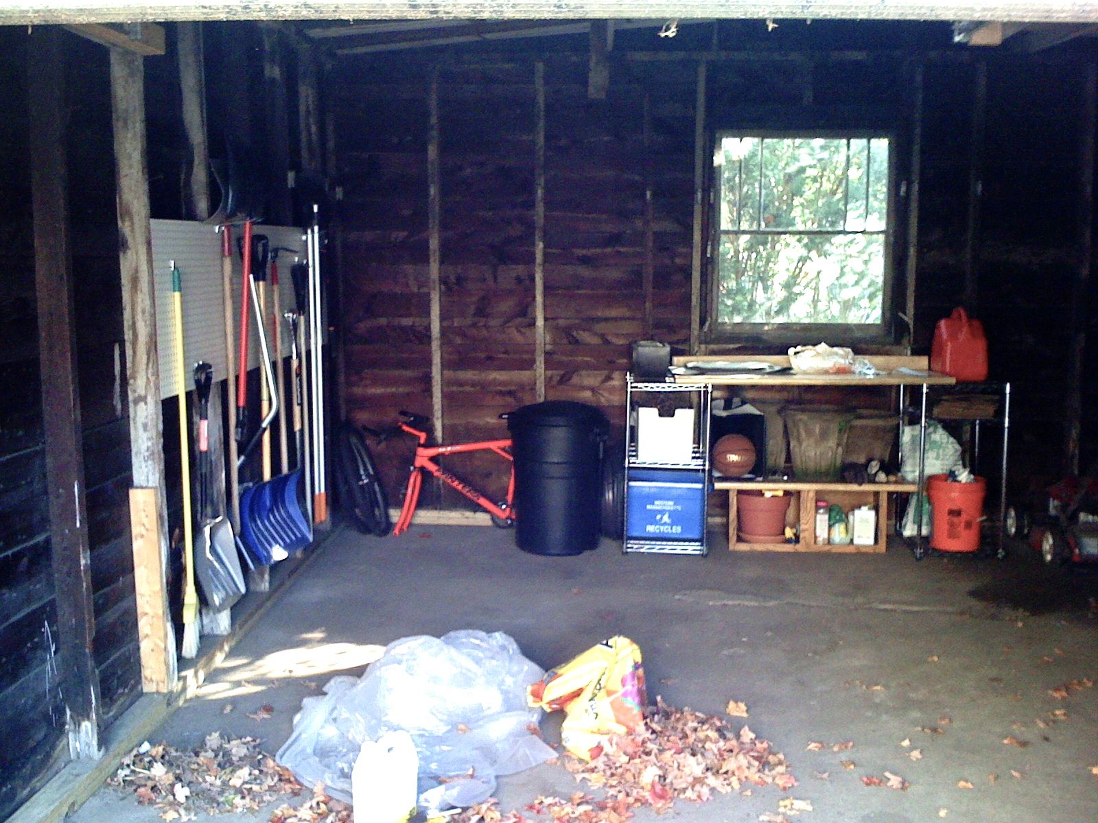 BLAST FROM THE PAST: The garage, circa 2007. This was how it looked after our first major clean-up. We had a station for potting plants, housing recycling, and yard tools. That's all gone now so that we can keep our lawnmower and snowblower in the garage with the car, and still have space for all the other goodies we've accumulated.
