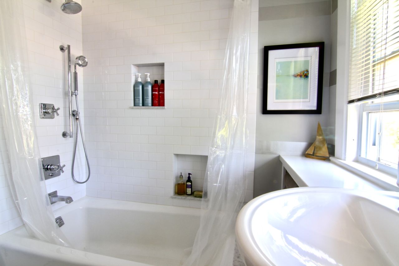 Family bath shower features niches for storage, a body spray hose, and new faucets/fixtures.