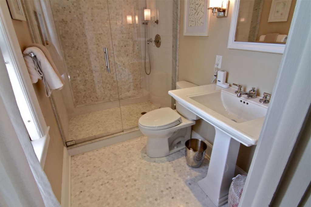 Master bathroom features marble floors with electric radiant heat, recessed medicine cabinet with custom frame molding, all new plumbing, and a Starphire glass shower door.