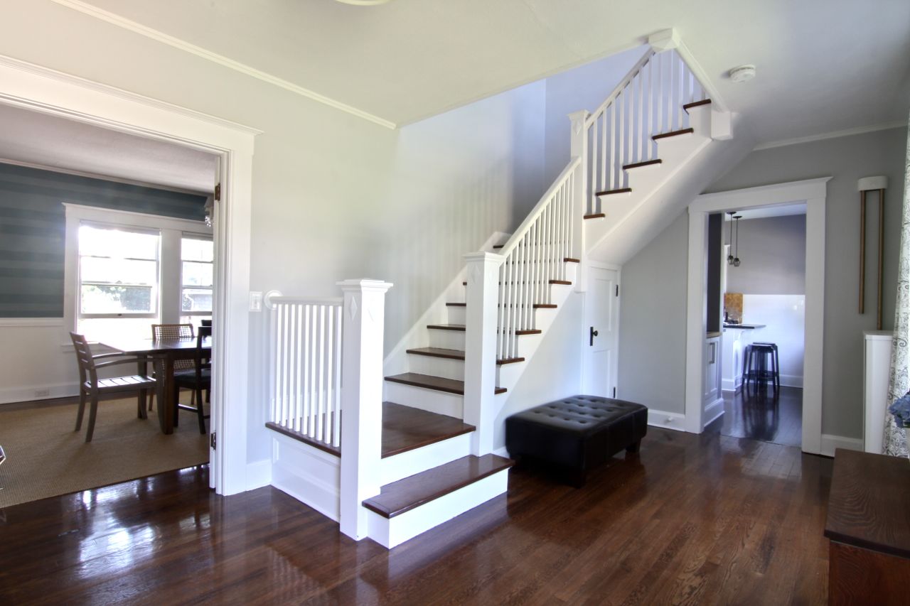 I love the way the staircase is both inviting, and signals a change in the purpose of the home. I believe it is evident that the public space ends at the staircase, but perhaps that's the old New Englander in me.