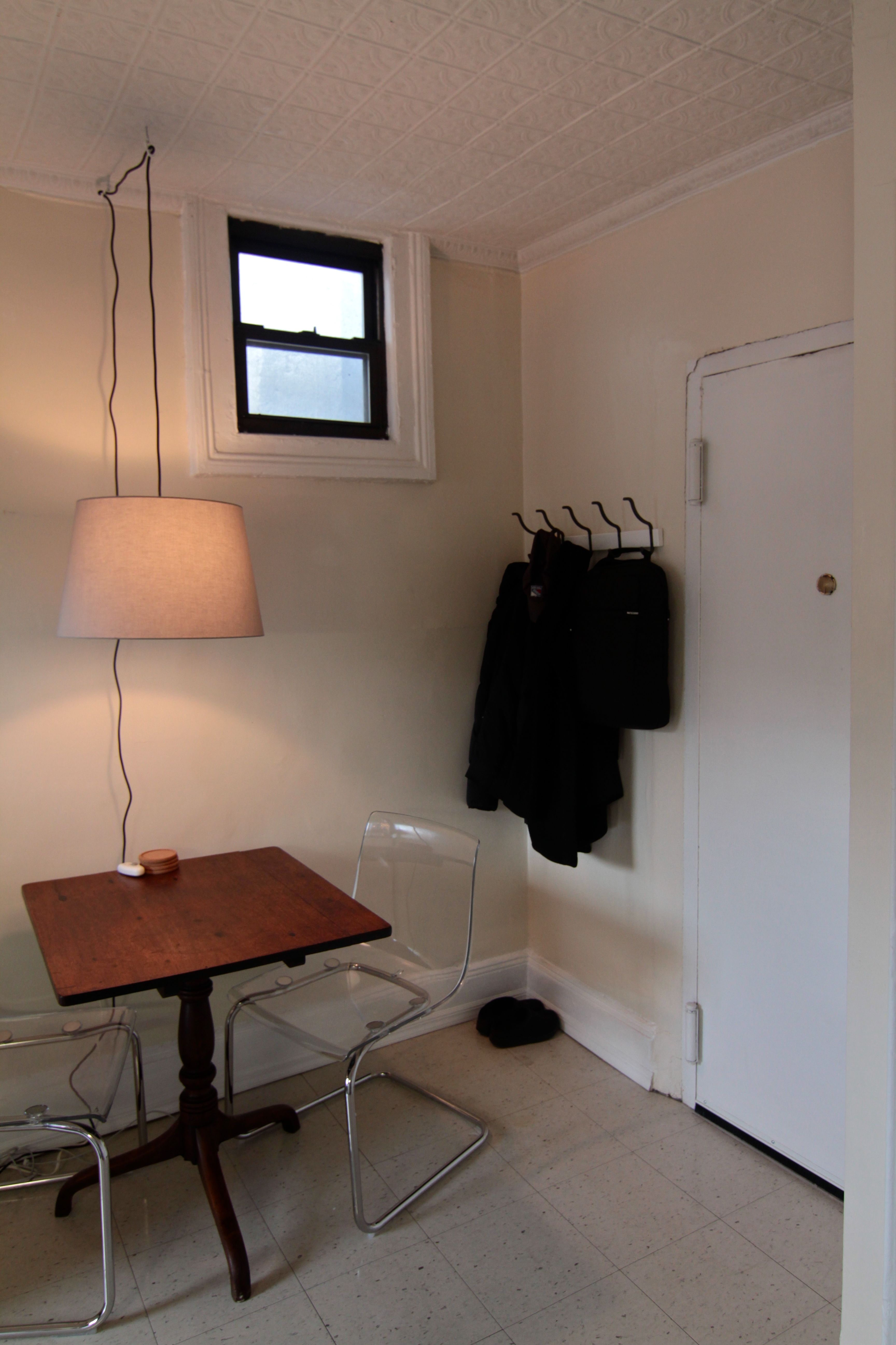We added a coat rack to create an entry (and to give us a place to hang our coats). This little window lets in a bit of light, and a breeze in warmer months.