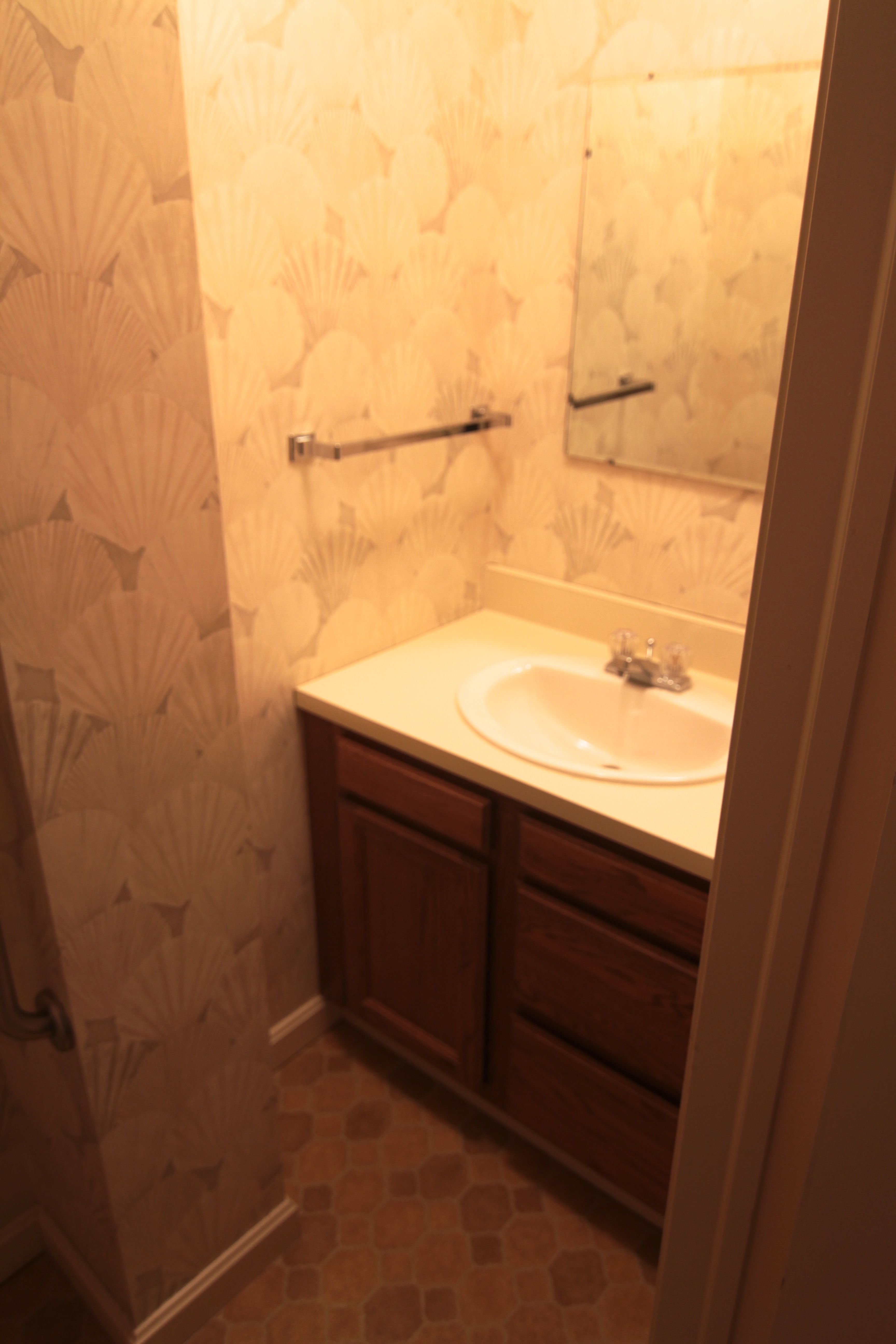 BEFORE: This powder room is basic, but it needn't be so ugly.