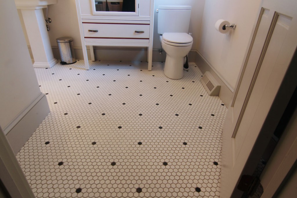 The vintage cabinet was sourced by the homeowners; the new layout makes the bathroom more usable.